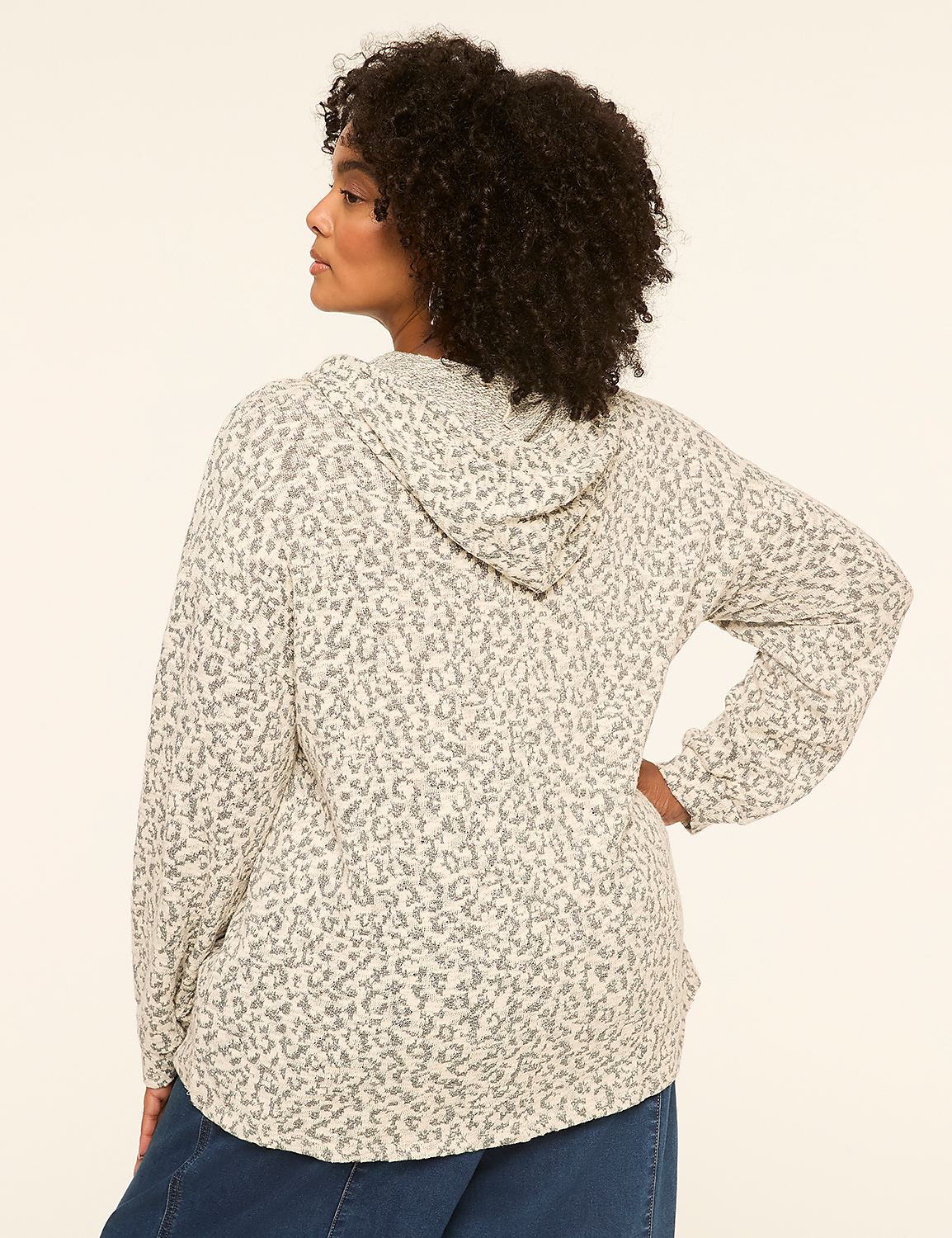 A woman in a leopard-print hoodie stands against a plain, light-colored background. Product Image 2