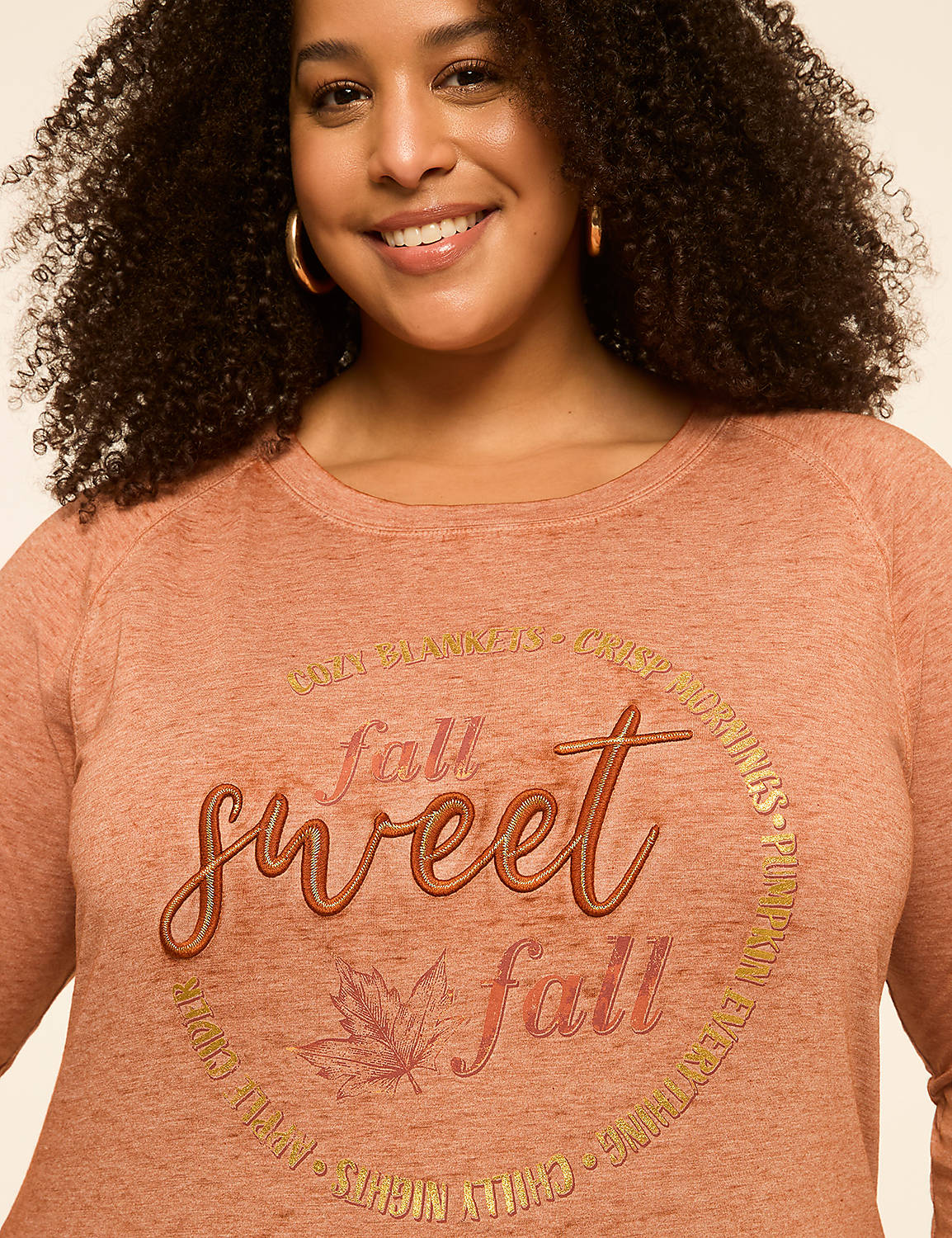 A woman smiles at the camera, wearing a rust-colored shirt with "fall sweet fall" printed on it, against a plain, light-colored background. Product Image 4
