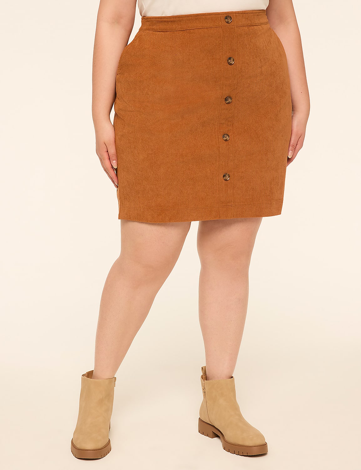 A person wearing a brown corduroy skirt and tan boots stands against a plain, light-colored background. Product Image 1