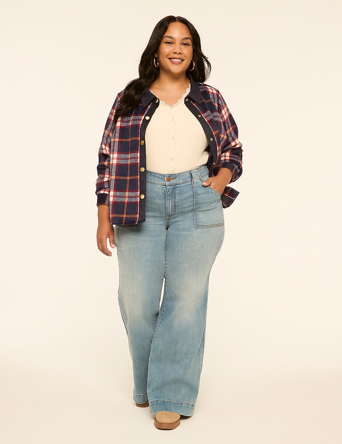 A smiling woman in a plaid shirt and wide-leg jeans stands against a plain, light-colored background. Product Image 3