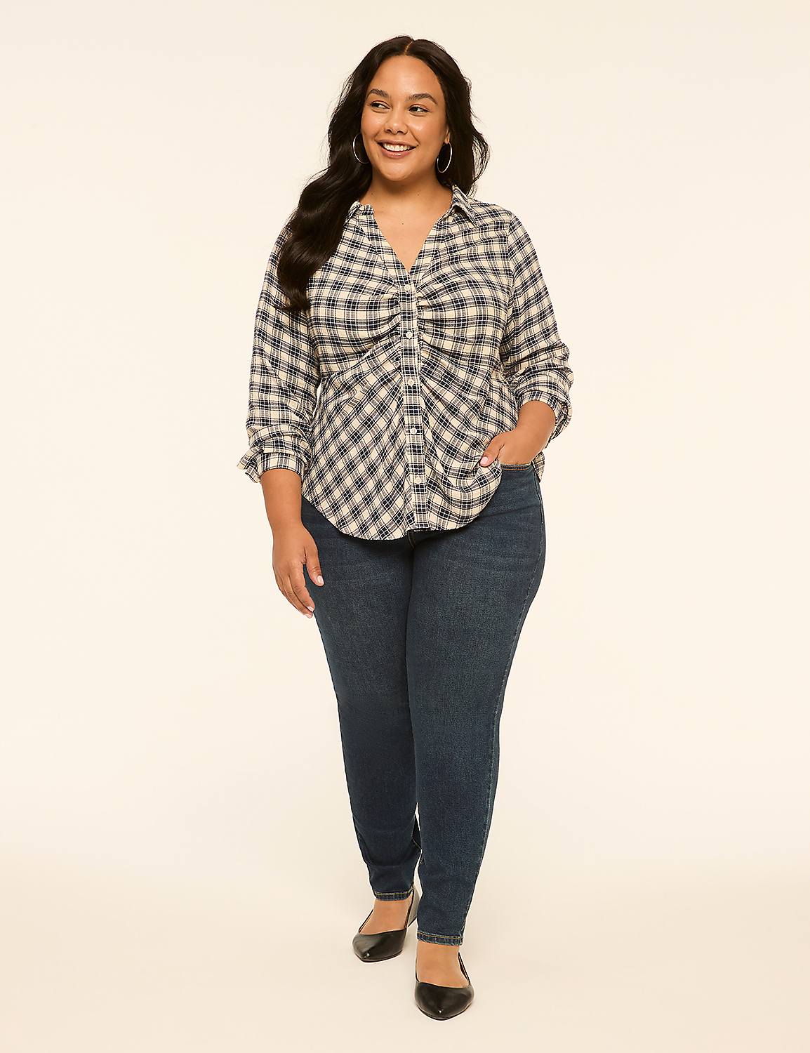 A woman in a plaid shirt and jeans stands against a plain, light-colored background. Product Image 3