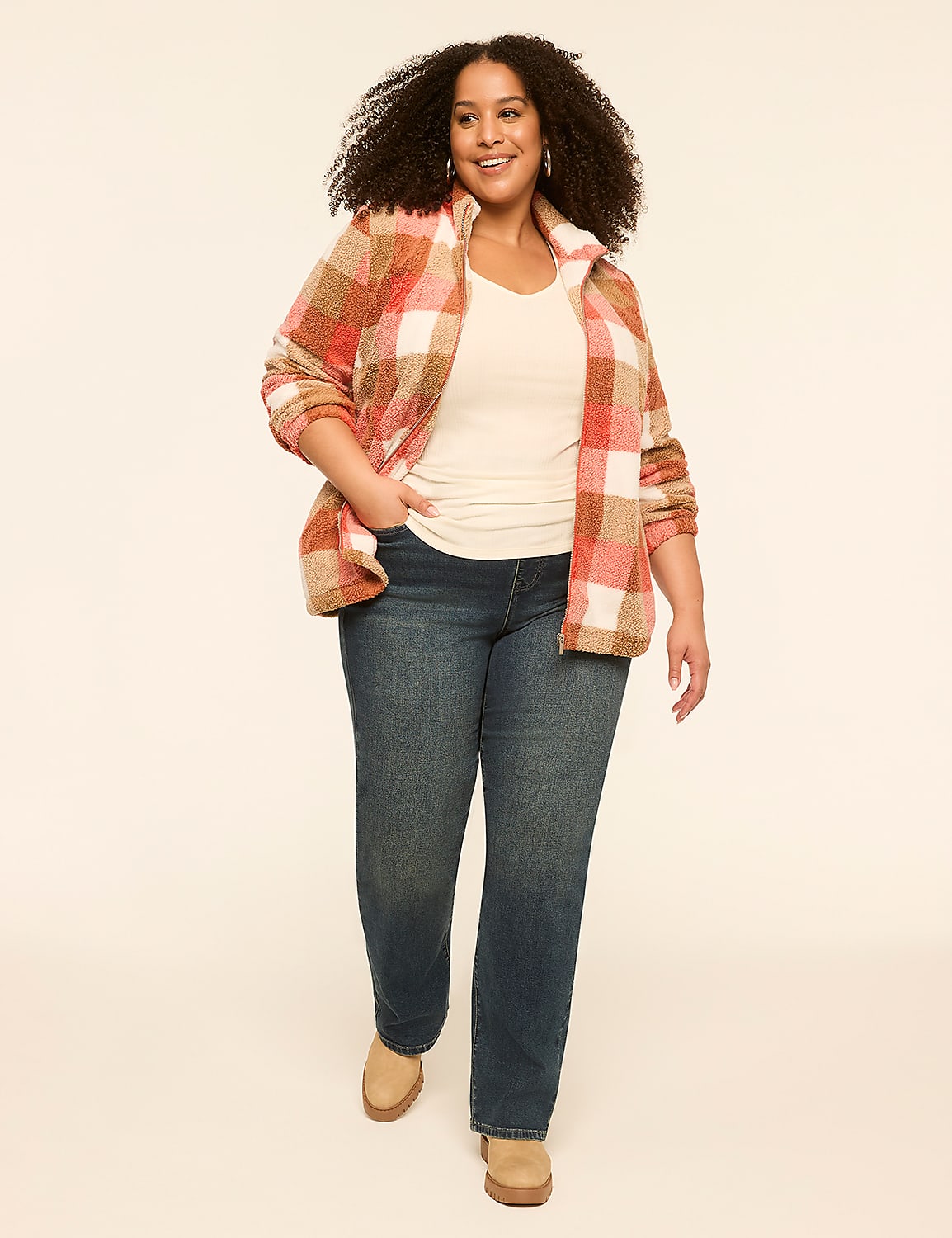 A smiling woman in a plaid jacket and jeans stands against a plain, light-colored background. Product Image 3