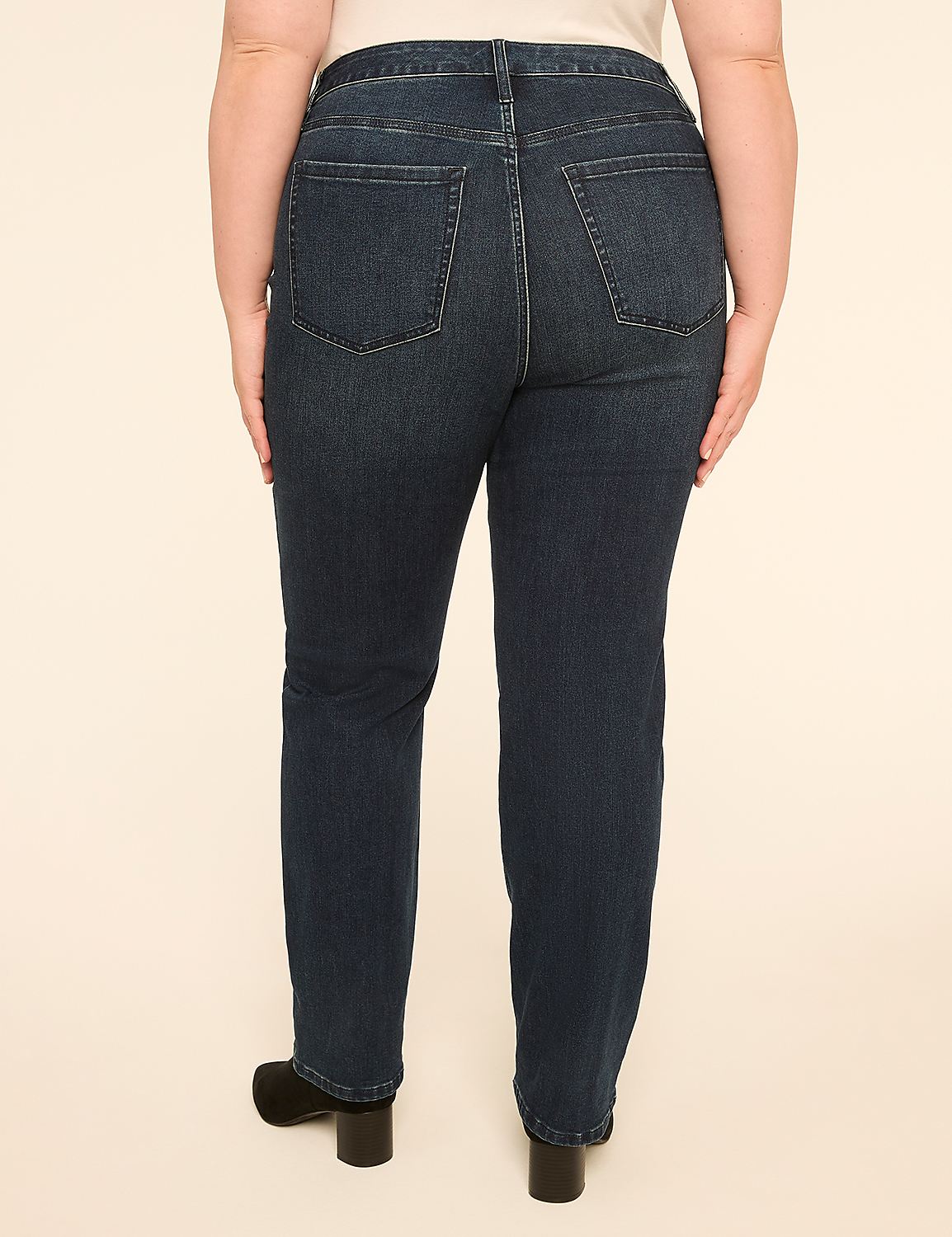 A person wearing dark wash denim jeans and black heels stands against a plain, light-colored background. Product Image 2