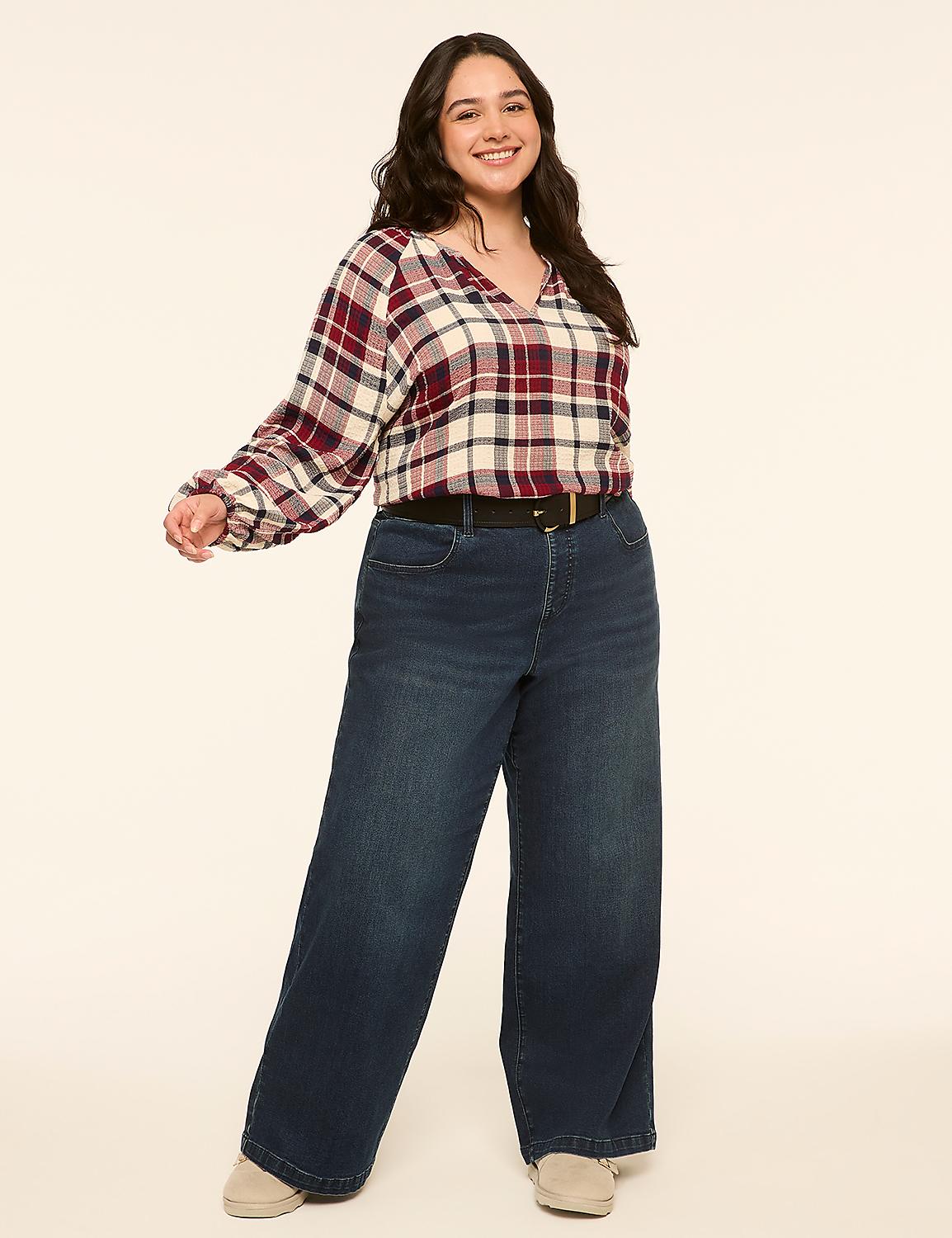 A smiling woman in a plaid blouse and wide-leg jeans stands against a plain, light-colored background. Product Image 3