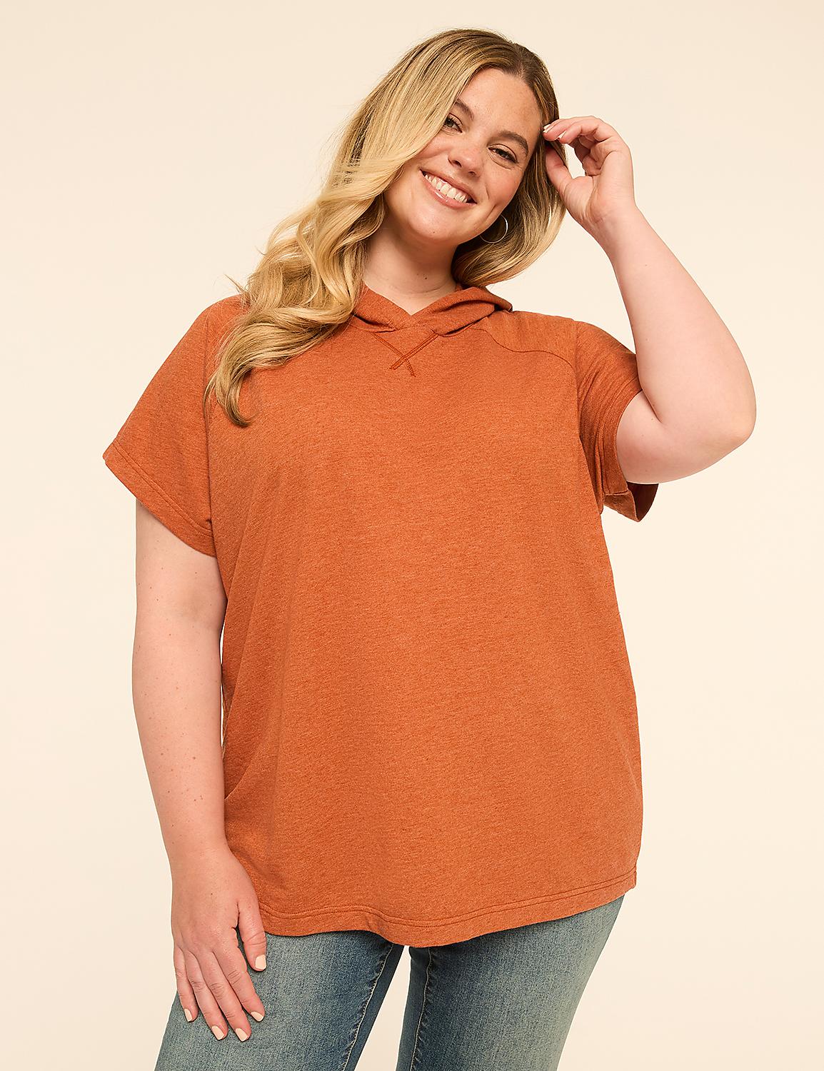 A woman in a rust-colored short-sleeved hoodie stands against a plain, light-colored background. Product Image 1