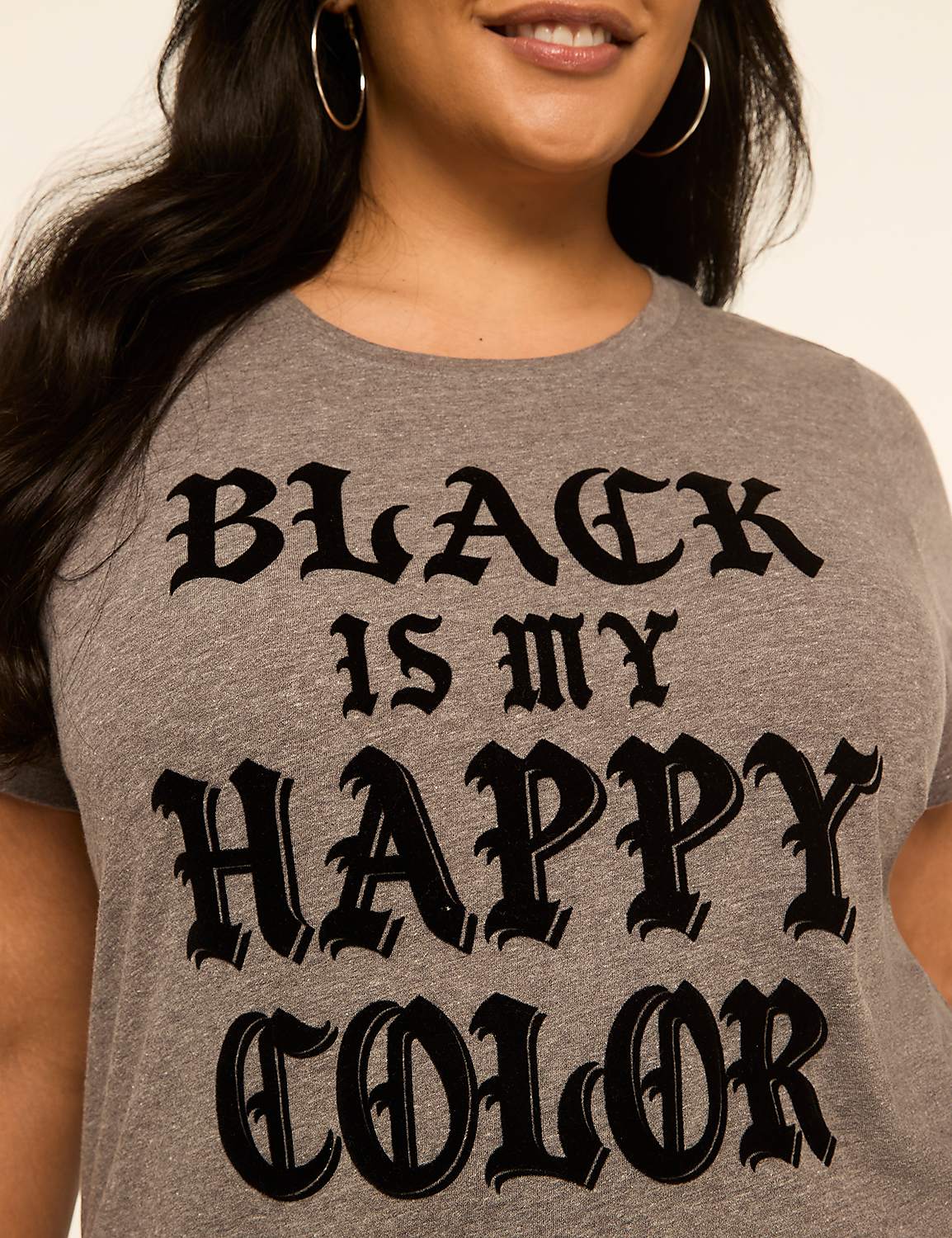 A woman in a grey t-shirt with the words "BLACK IS MY HAPPY COLOR" in gothic font smiles against a plain white background. Product Image 4