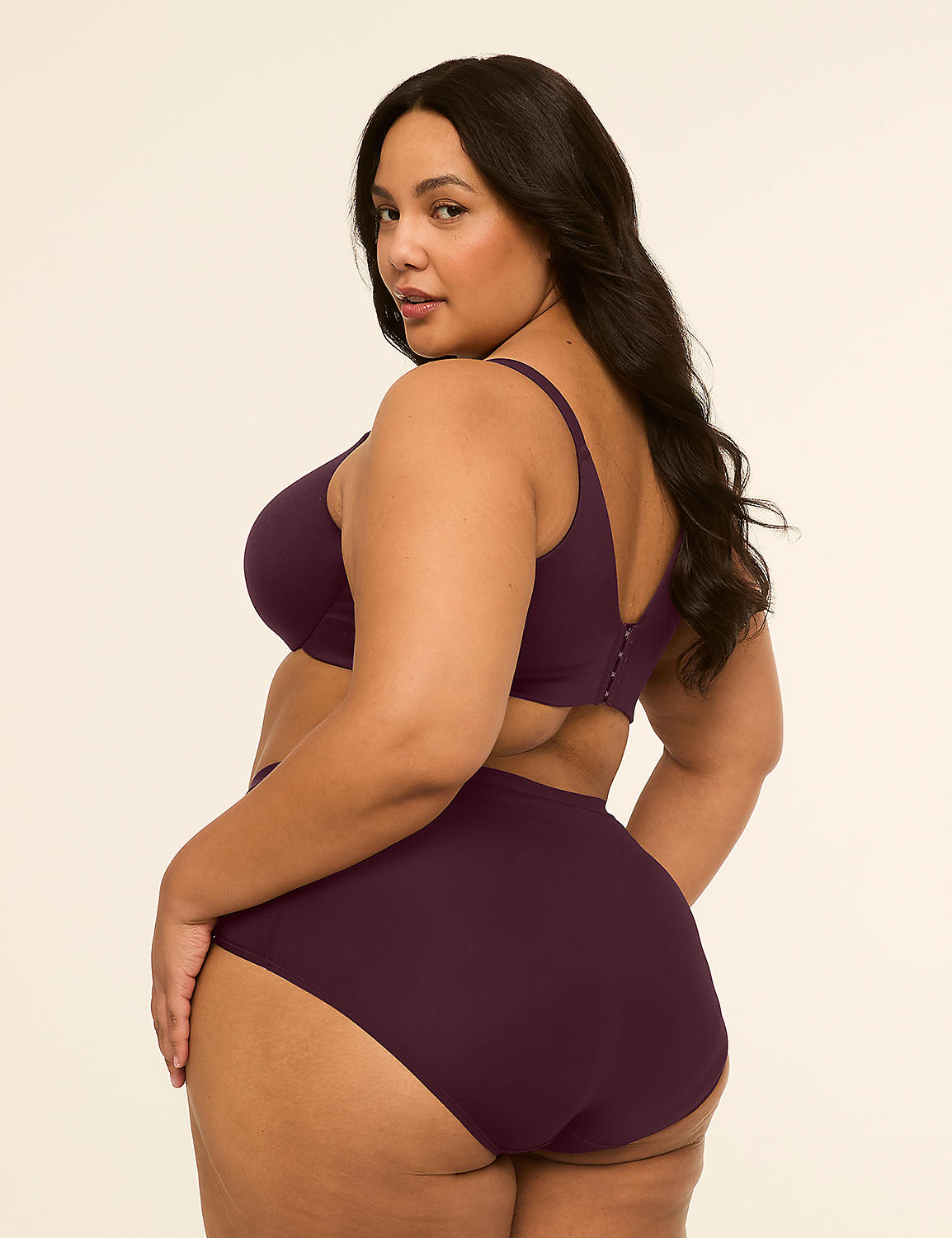 A plus-size woman in a plum-colored bra and high-waisted underwear poses against a plain, light-colored background. Product Image 2