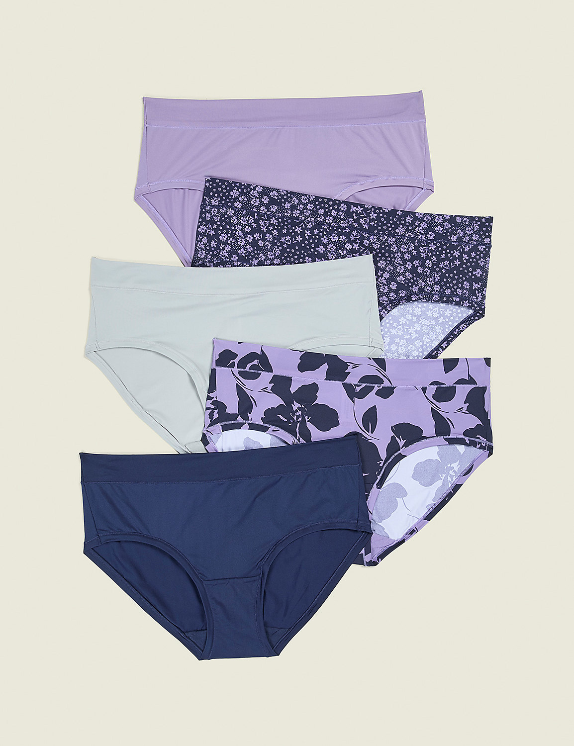 Five pairs of women's underwear, in solid colors and floral patterns, are neatly arranged against a plain, light beige background. Product Image 1