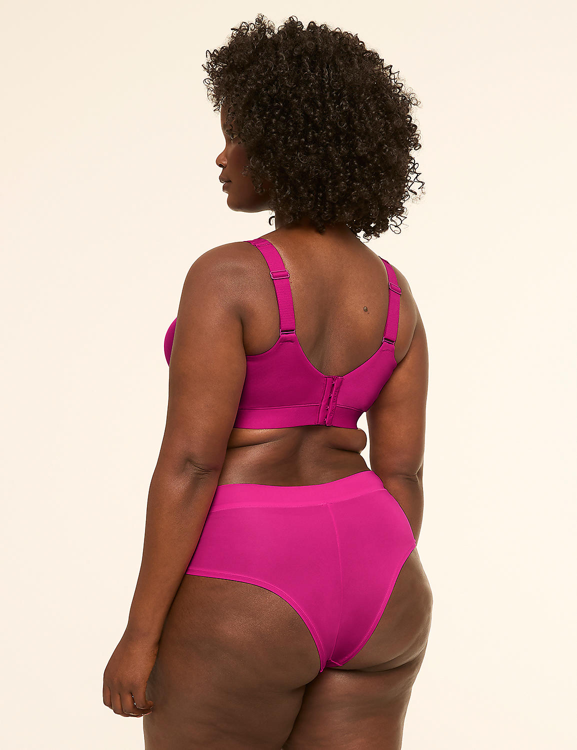 A woman in a magenta bra and underwear stands against a plain cream background. Product Image 2