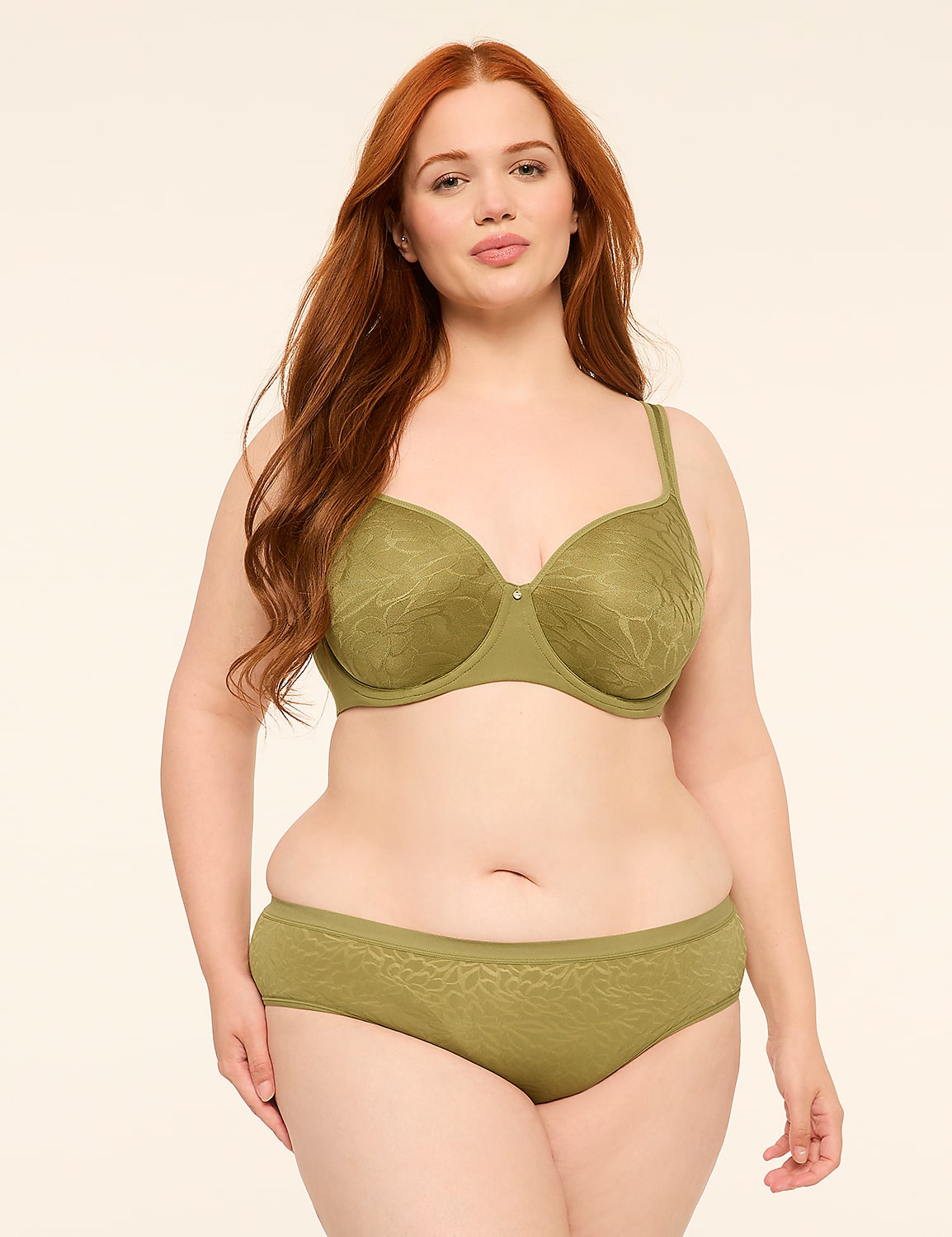 A woman with red hair stands in a plain, light-colored studio, wearing a green bra and underwear. Product Image 4