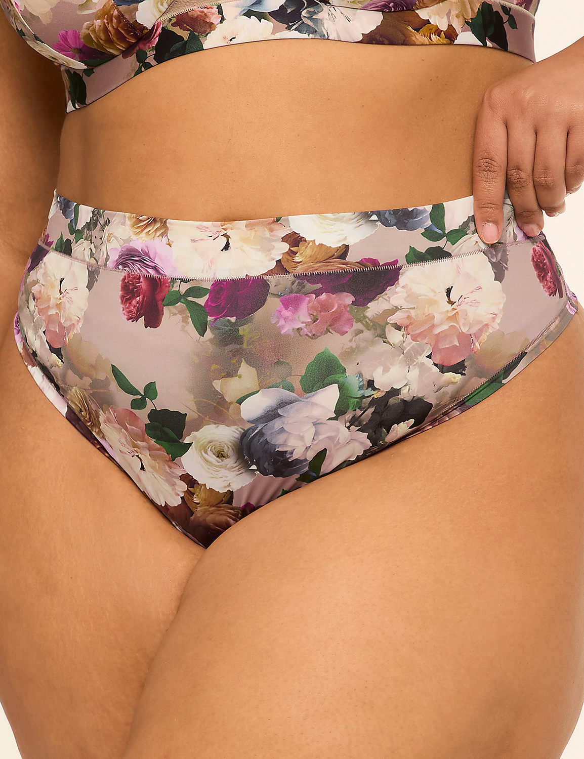 A person wears high-waisted floral underwear in the foreground, with a plain background. Product Image 1