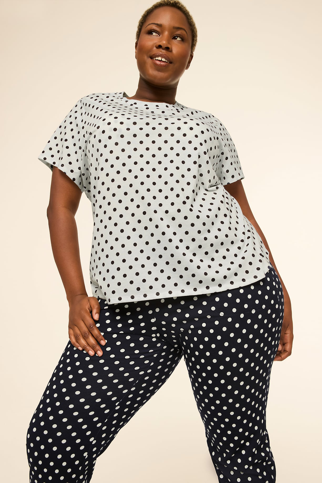 A woman in a polka-dot top and pants poses against a plain, light-colored background. Product Image 8