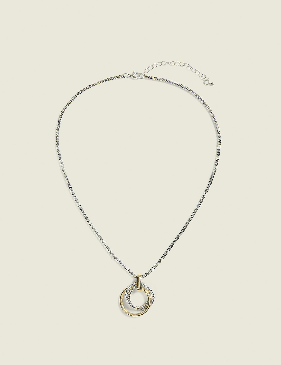 A silver chain necklace with a gold and silver interlocking pendant rests against a plain, light beige background. Product Image 1