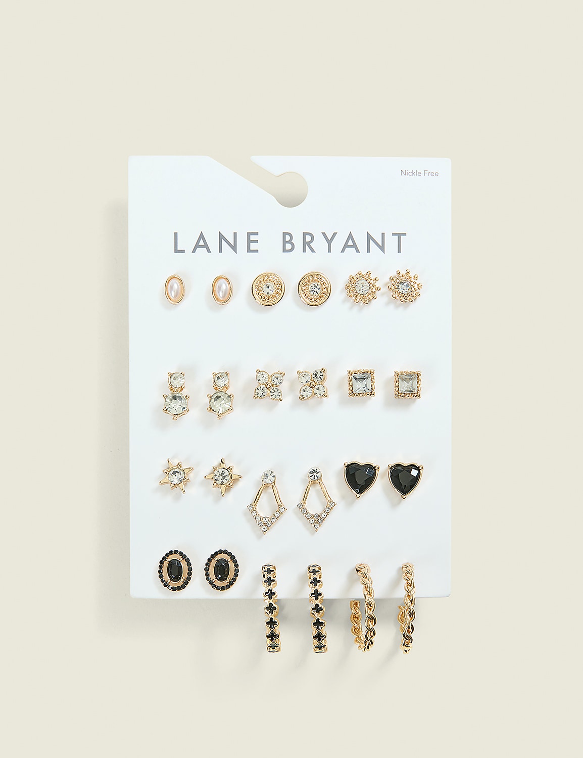 A white card displays an assortment of gold and black earrings in various shapes and sizes, set against a plain, light brown background. Product Image 1
