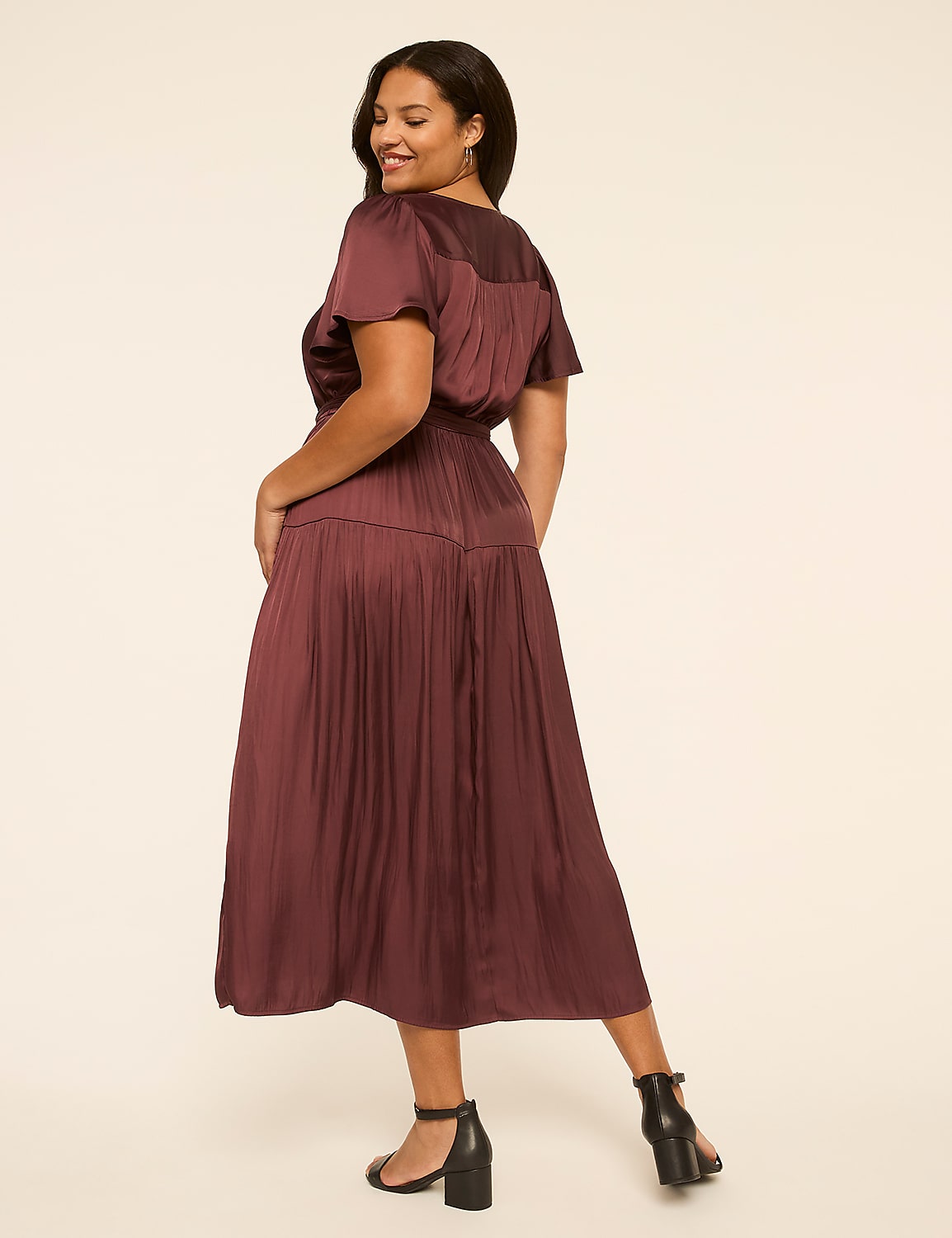 A woman in a burgundy dress poses against a plain, light-colored background. Product Image 2