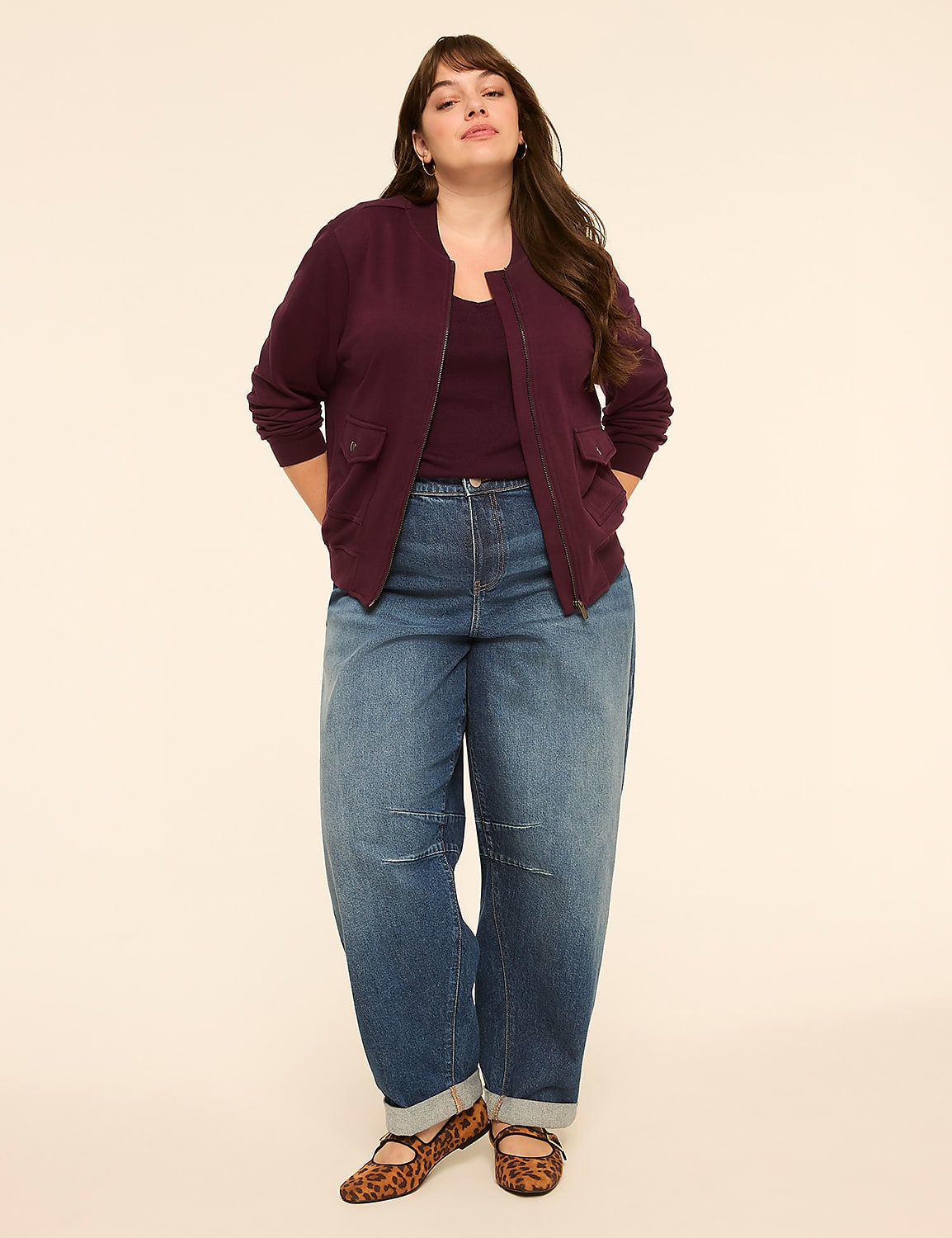 A woman in a burgundy bomber jacket and loose-fitting jeans stands against a plain, light-colored background. Product Image 3
