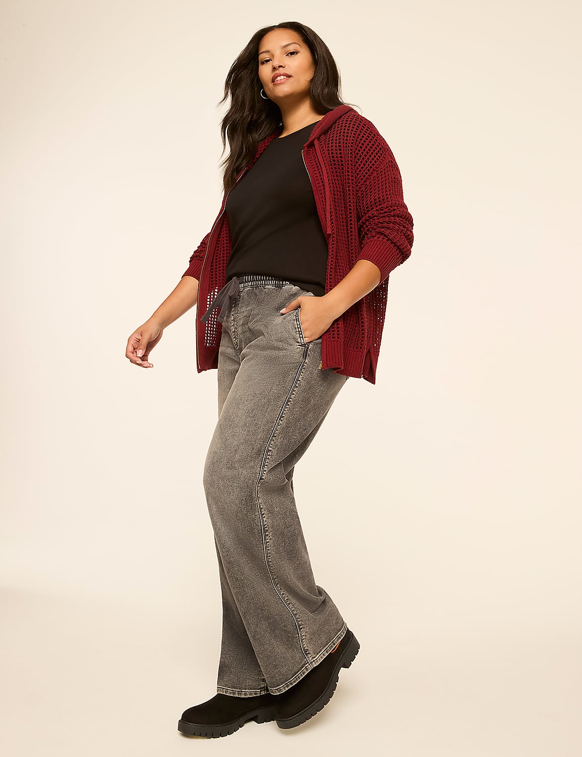 A woman in a maroon hooded cardigan and grey wide-leg pants poses against a plain, light-colored background. Product Image 3