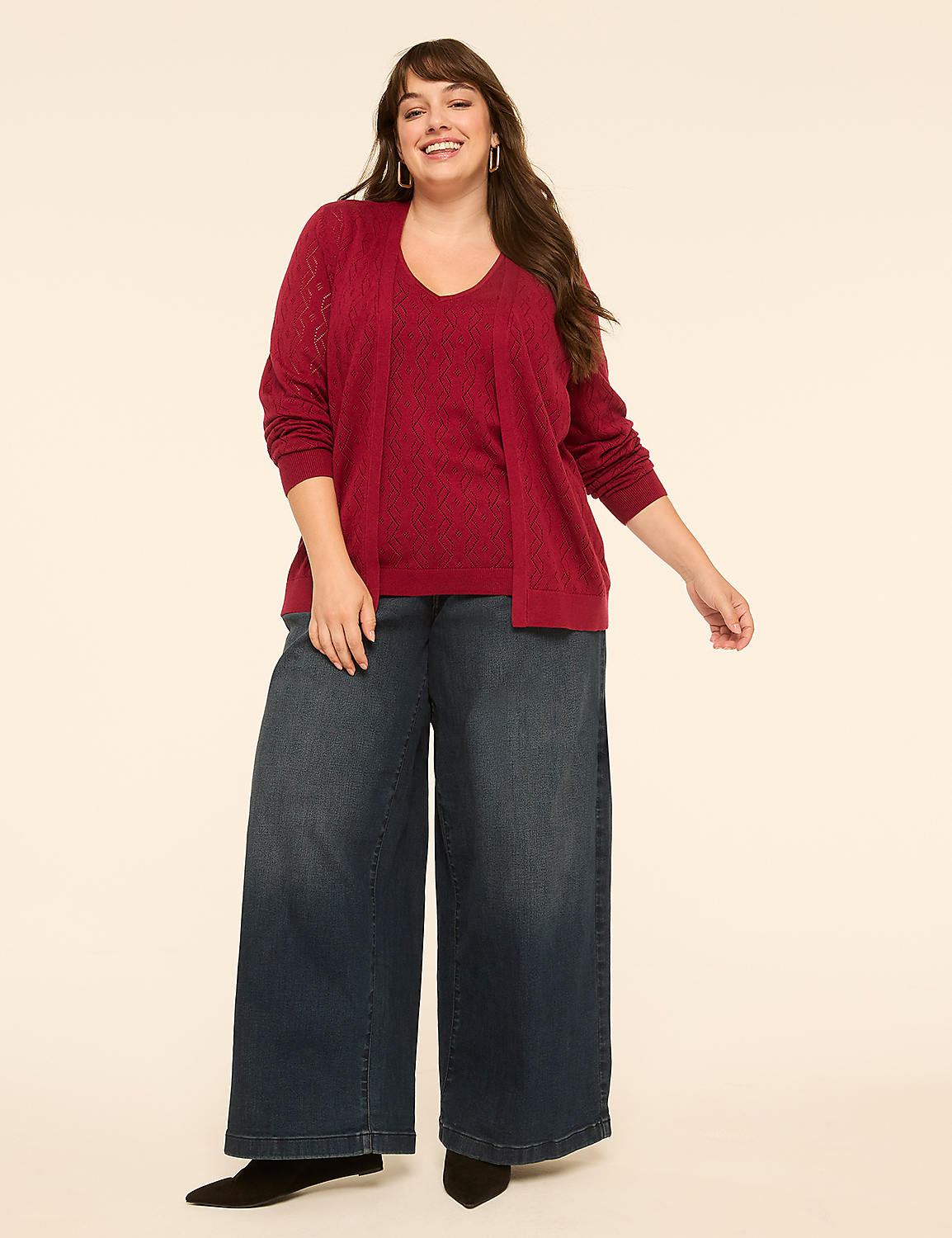 A smiling woman in a maroon sweater set and wide-leg jeans stands against a plain cream background. Product Image 3