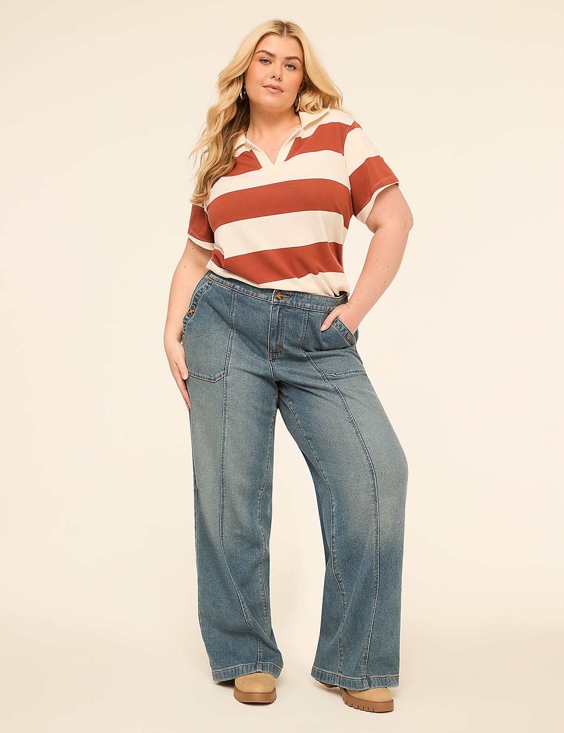 A woman with blonde hair stands in the foreground wearing a striped polo shirt and wide-leg jeans against a plain, light-colored background. Product Image 3