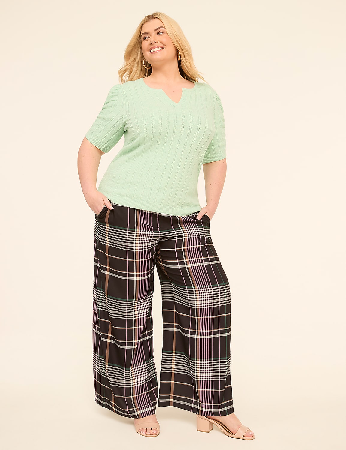 A smiling woman in a mint green top and plaid wide-leg pants stands against a plain, light-colored background. Product Image 3