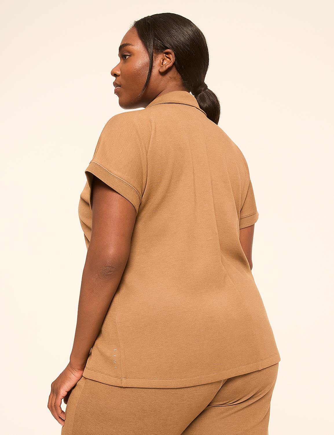 A woman in a brown polo shirt and pants stands against a plain, light-colored background. Product Image 2