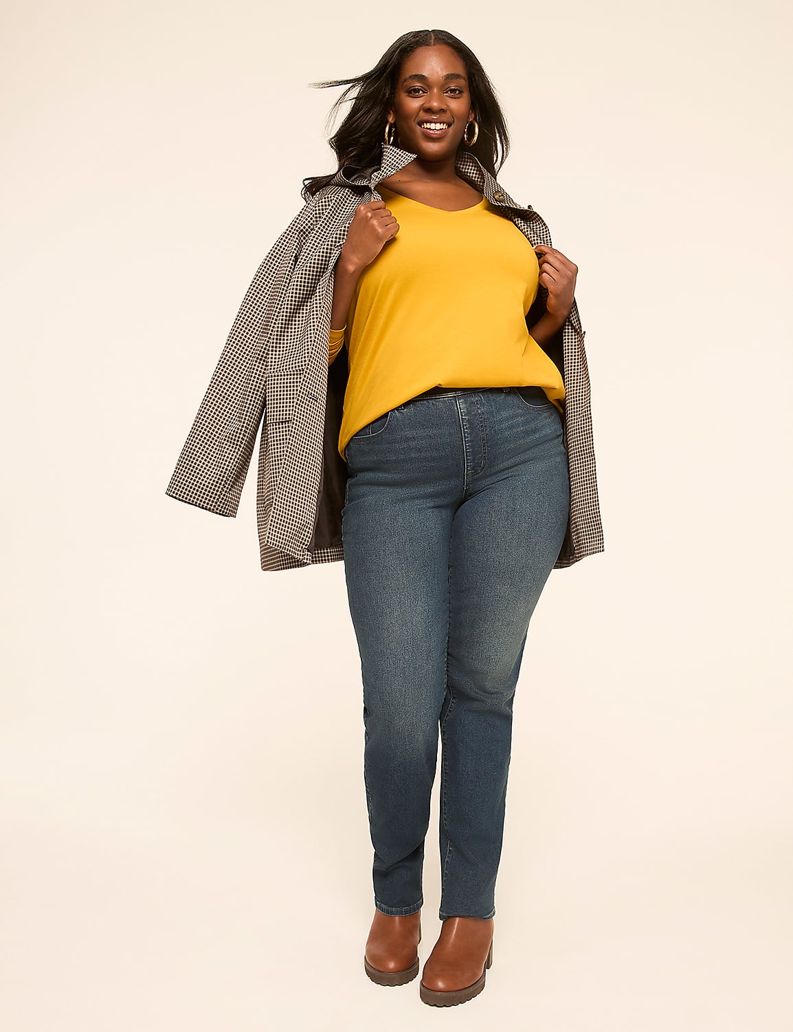 A smiling woman in a yellow top, blue jeans, and a patterned jacket stands against a plain, light-colored background. Product Image 3