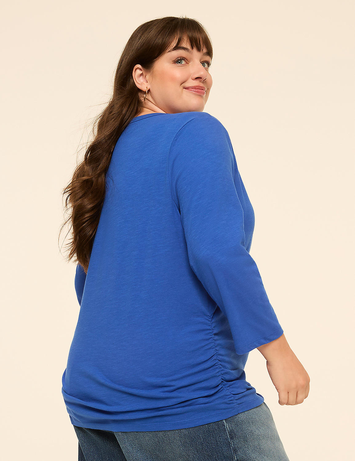 A woman in a blue shirt and jeans stands against a plain, light-colored background. Product Image 2