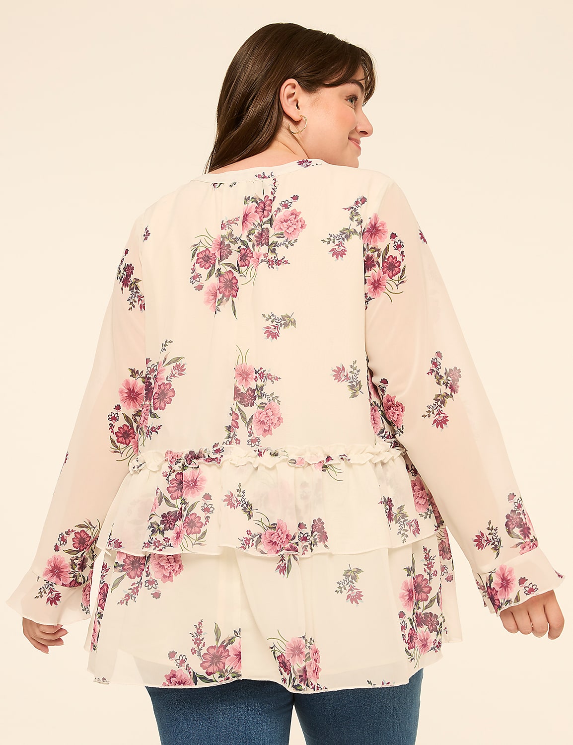 A woman in a floral print blouse with ruffled tiers stands against a plain, light-colored background. Product Image 2