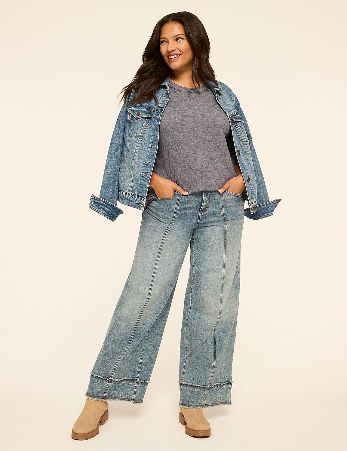 A smiling woman in a denim jacket and wide-leg jeans stands against a plain, light-colored background. Product Image 3