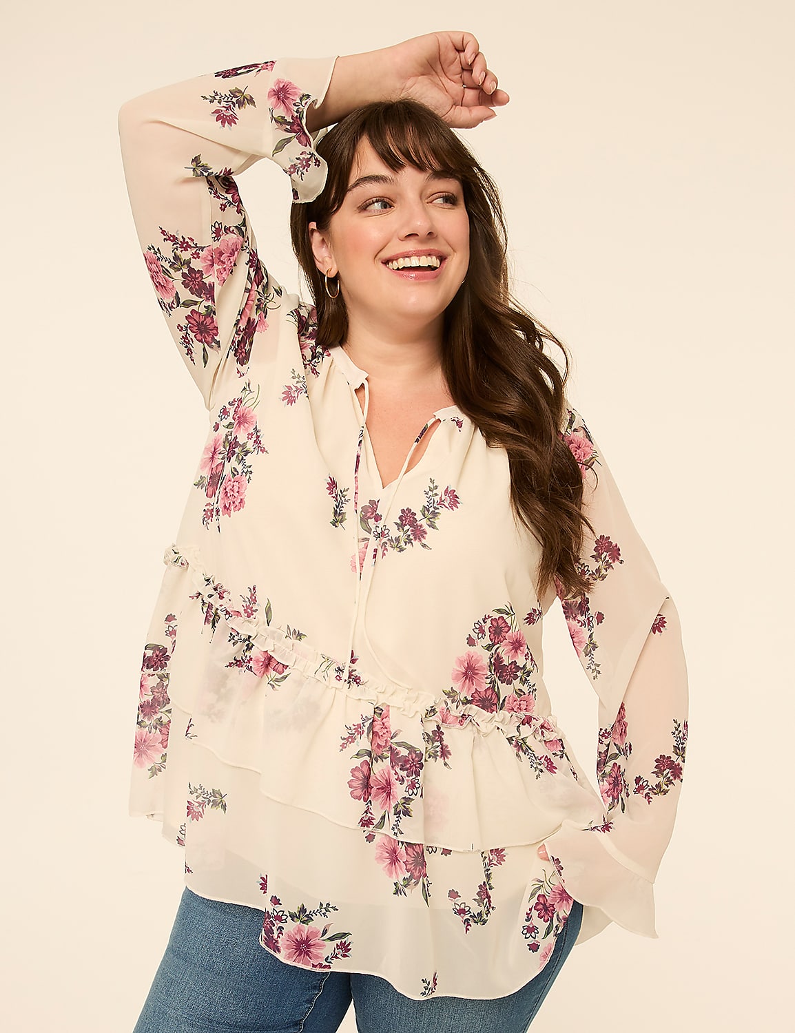 A smiling woman in a floral blouse poses against a plain, light-colored background. Product Image 1