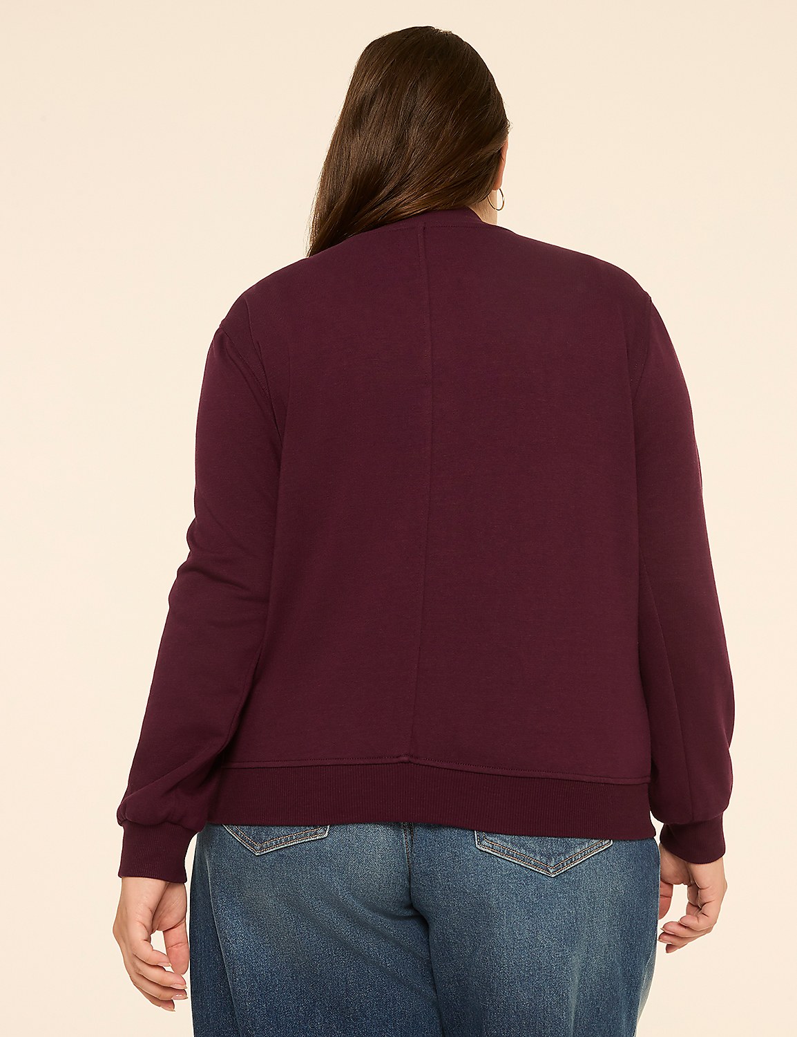 A woman in a burgundy sweatshirt and blue jeans stands against a plain, light-colored background. Product Image 2