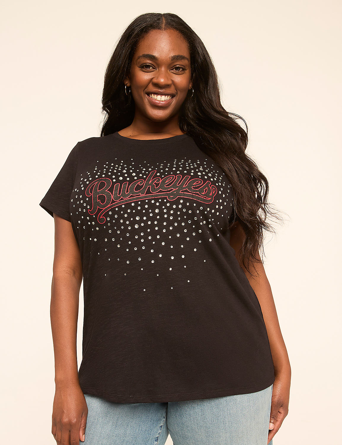 A smiling woman in a black t-shirt with "Buckeyes" written in glitter stands against a plain, light-colored background. Product Image 1