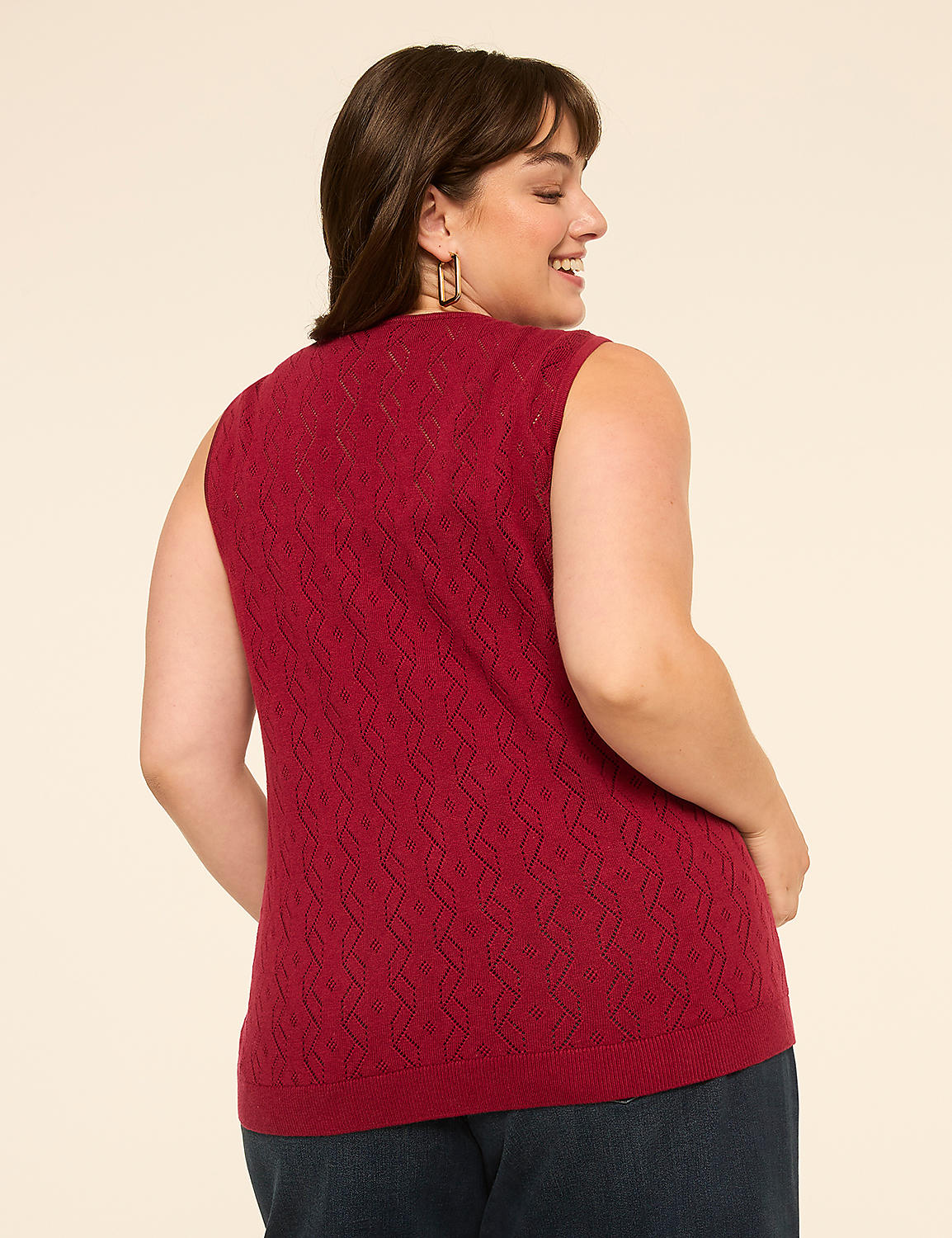 A woman in a red knit vest stands against a plain beige background. Product Image 2