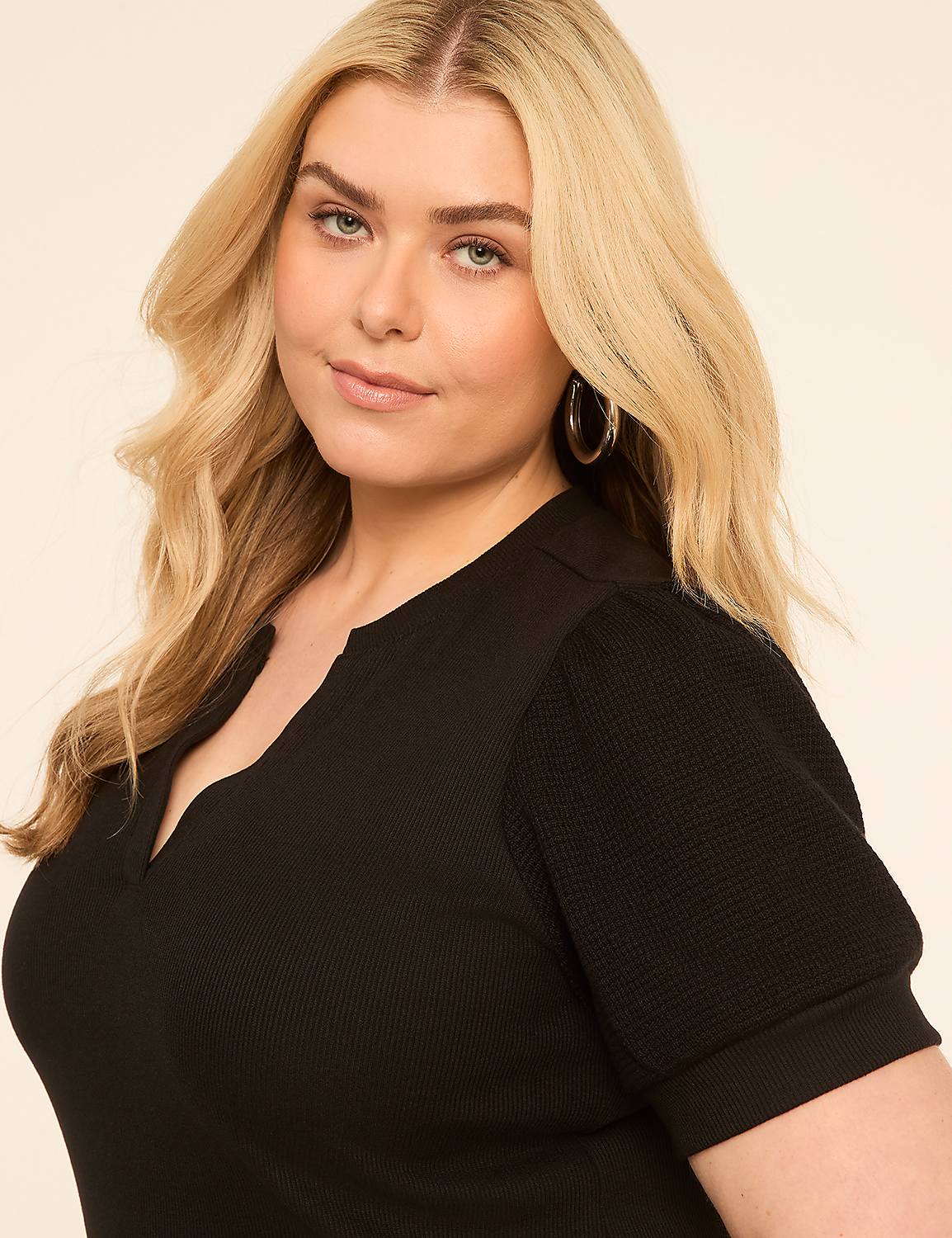 A blonde woman in a black top is posed against a plain, light-colored background. Product Image 4