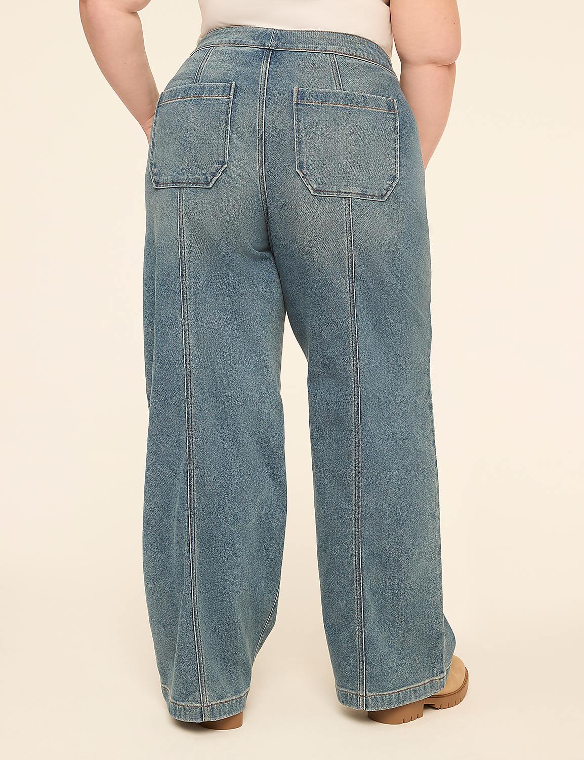A person stands in light-wash denim wide-leg jeans with a plain background. Product Image 2