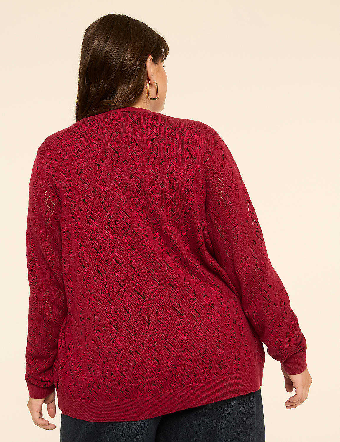 A woman in a red, patterned sweater stands against a plain, light-colored background. Product Image 2