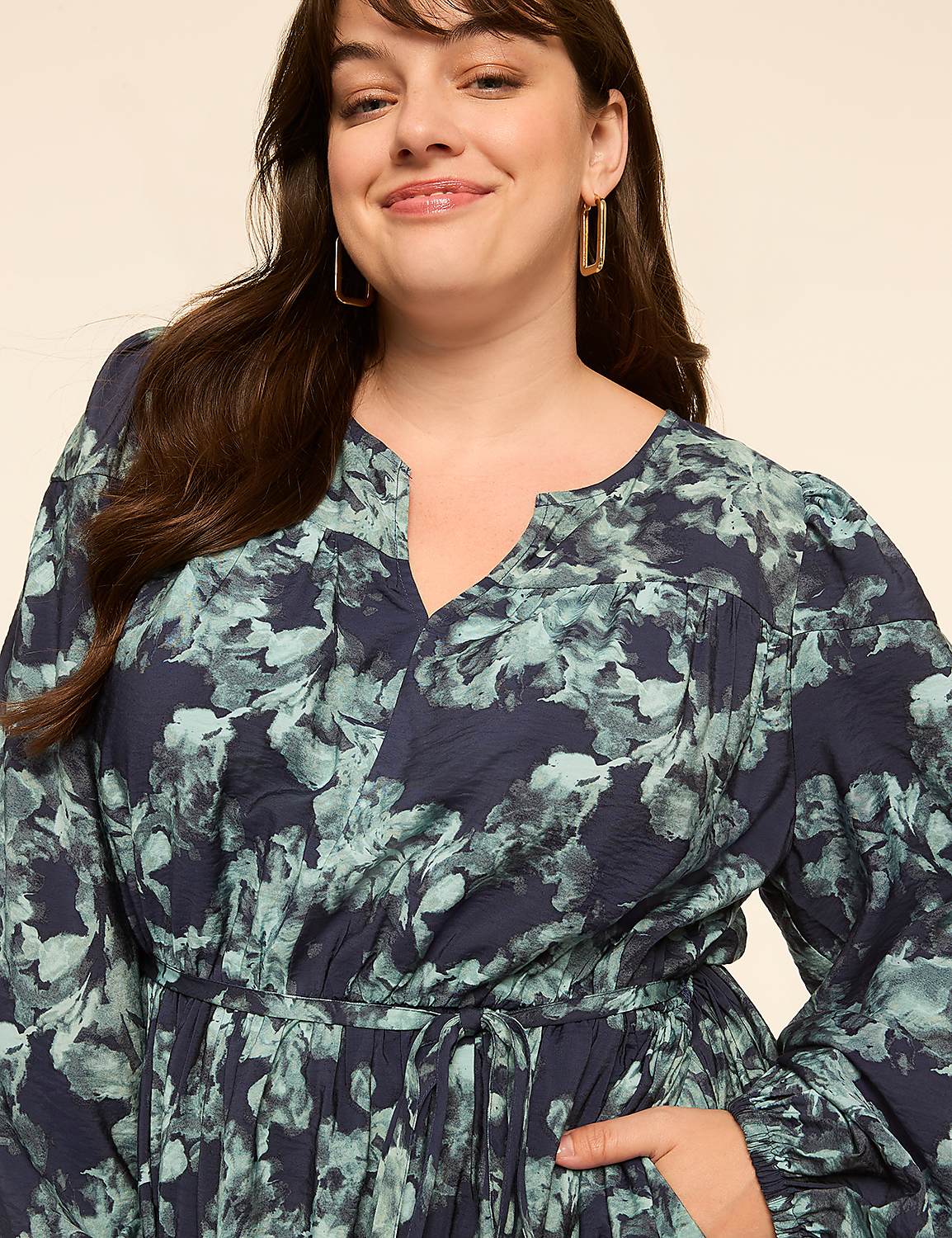A woman in a floral dress smiles at the camera against a plain, light-colored background. Product Image 3