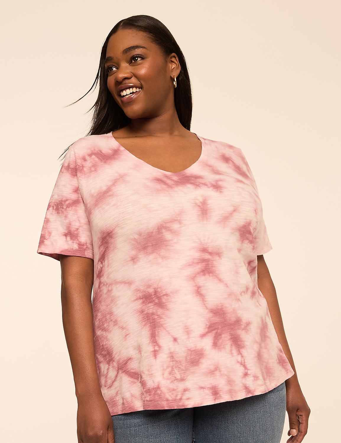 A smiling woman in a pink tie-dye t-shirt stands against a plain, peachy background. Product Image 1