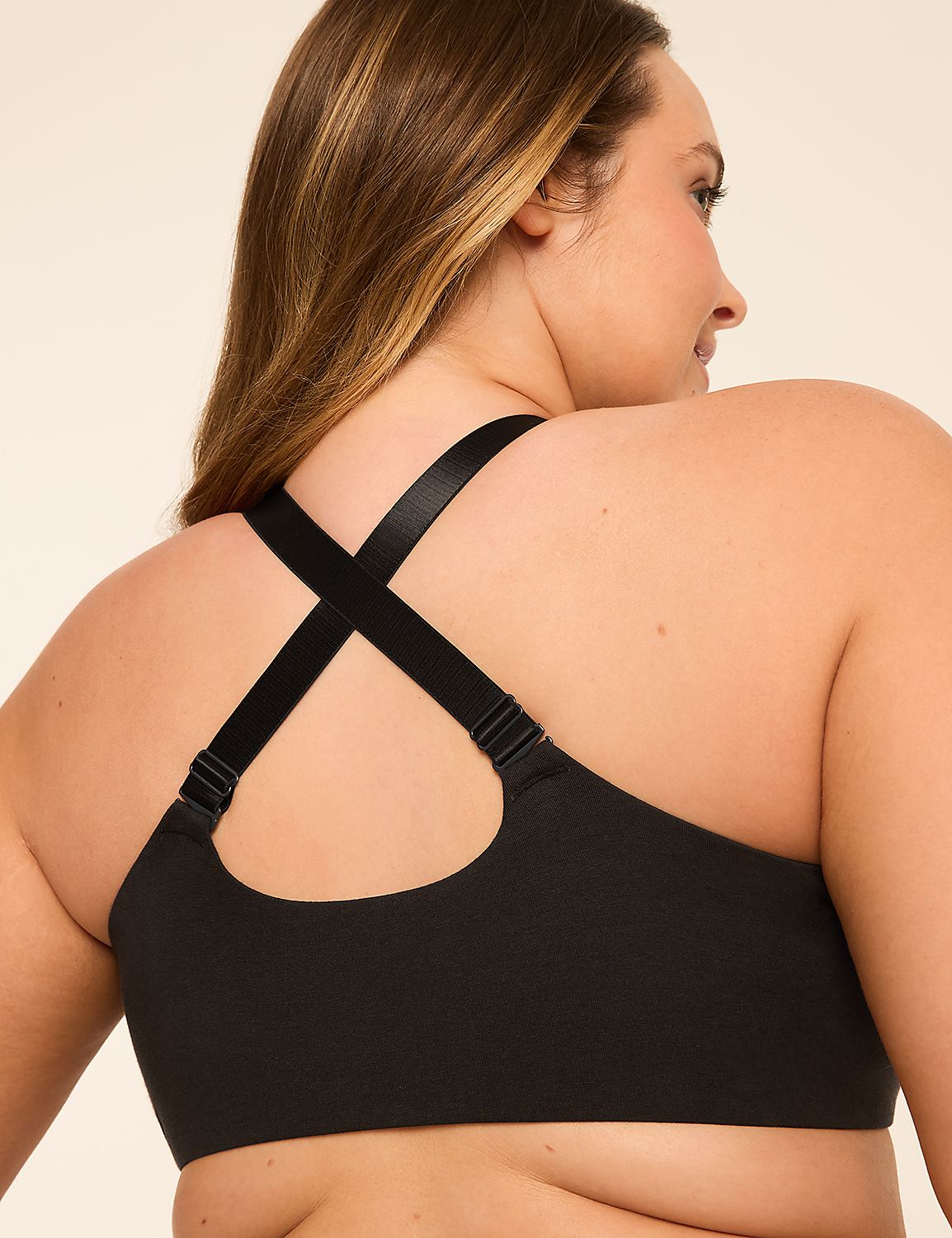 A woman's back is shown in the foreground, wearing a black bra with crisscrossed straps, against a plain, light-colored background. Product Image 5