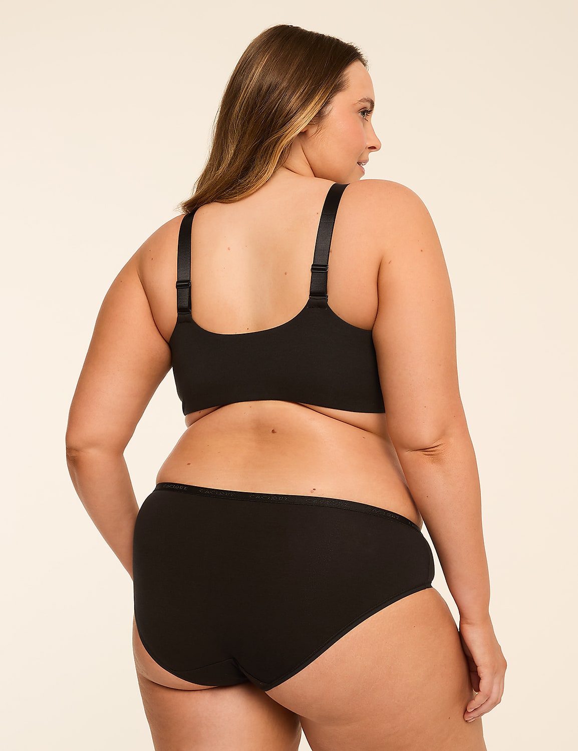 A woman in black lingerie stands against a plain, light-colored background. Product Image 2