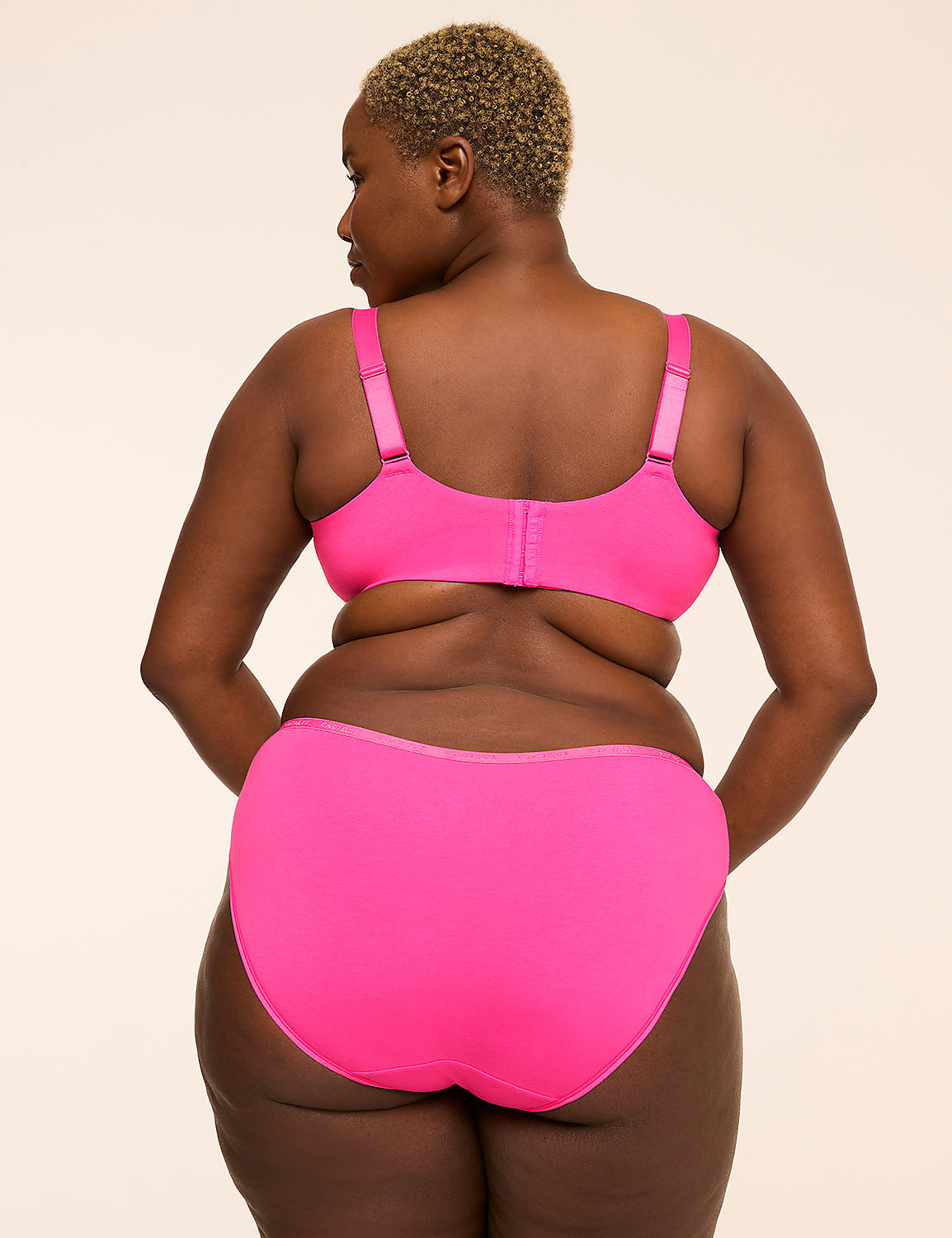 A woman in a bright pink bra and underwear stands with her back to the camera against a plain, light-colored background. Product Image 2