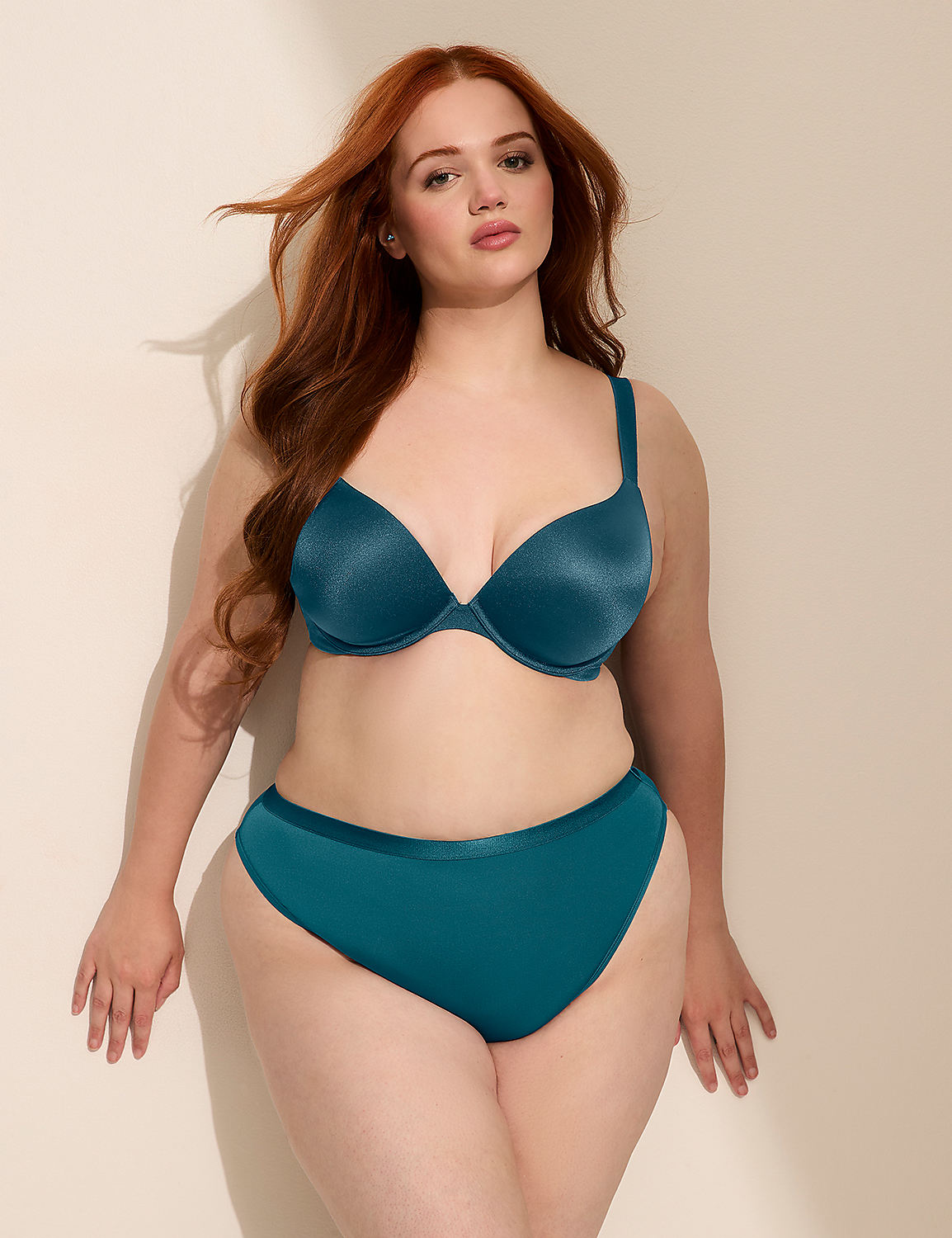 A woman with red hair poses in teal lingerie against a plain, softly lit background. Product Image 3