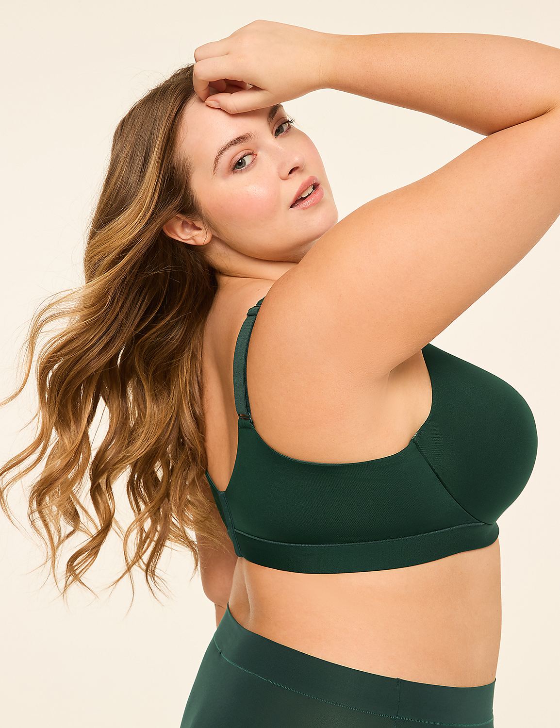A woman with long, wavy brown hair poses in a dark green bra and matching bottoms against a plain, light background. Product Image 3