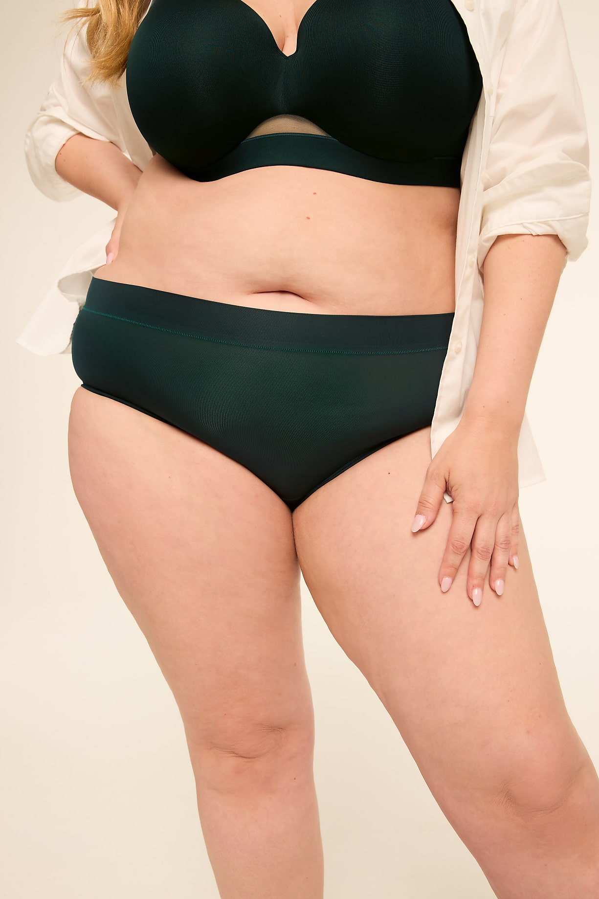 A woman in dark green underwear and a white shirt stands against a plain, light background. Product Image 6