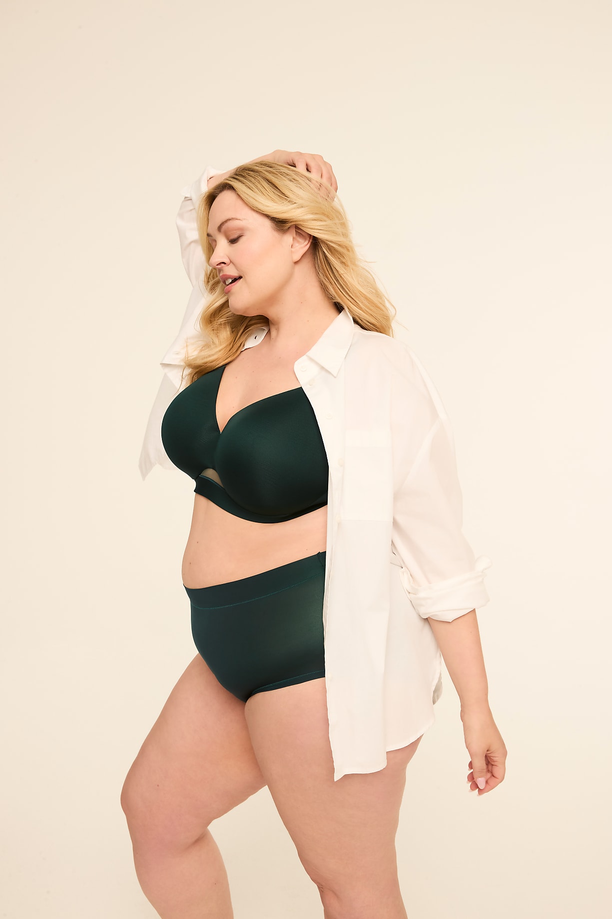 A blonde woman in a green bra and underwear, with a white shirt open, poses against a plain, light-colored background. Product Image 8