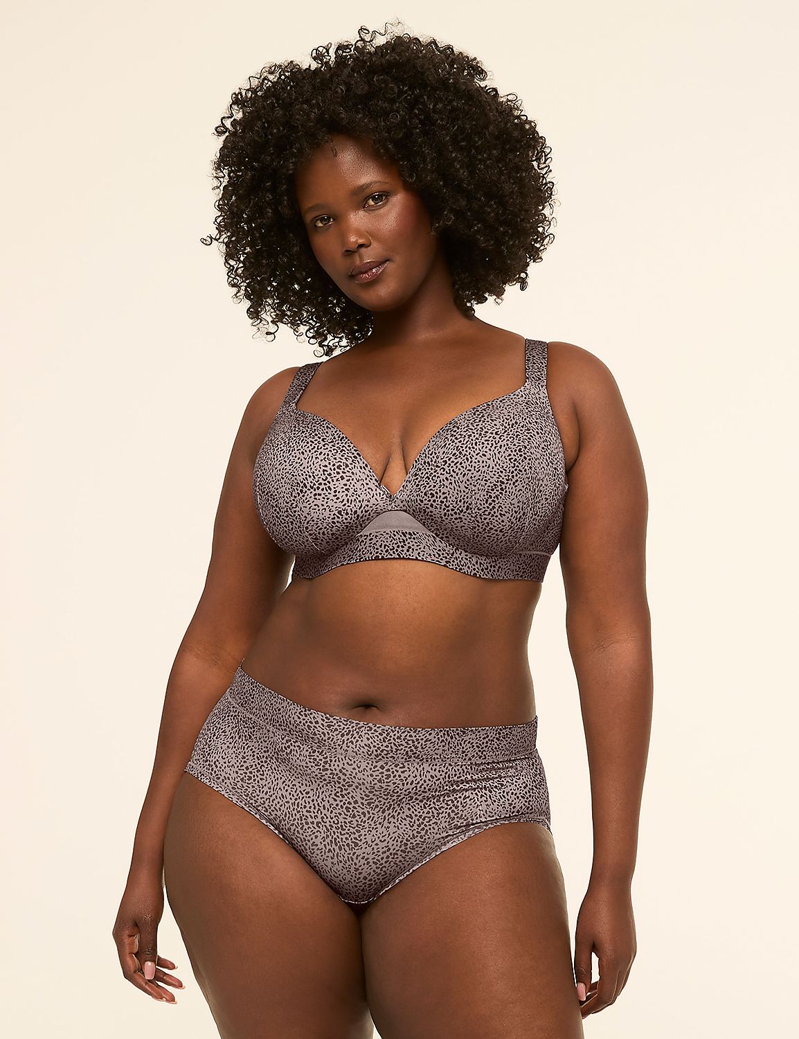 A woman with dark curly hair poses in a patterned bra and underwear against a plain, light-colored background. Product Image 4