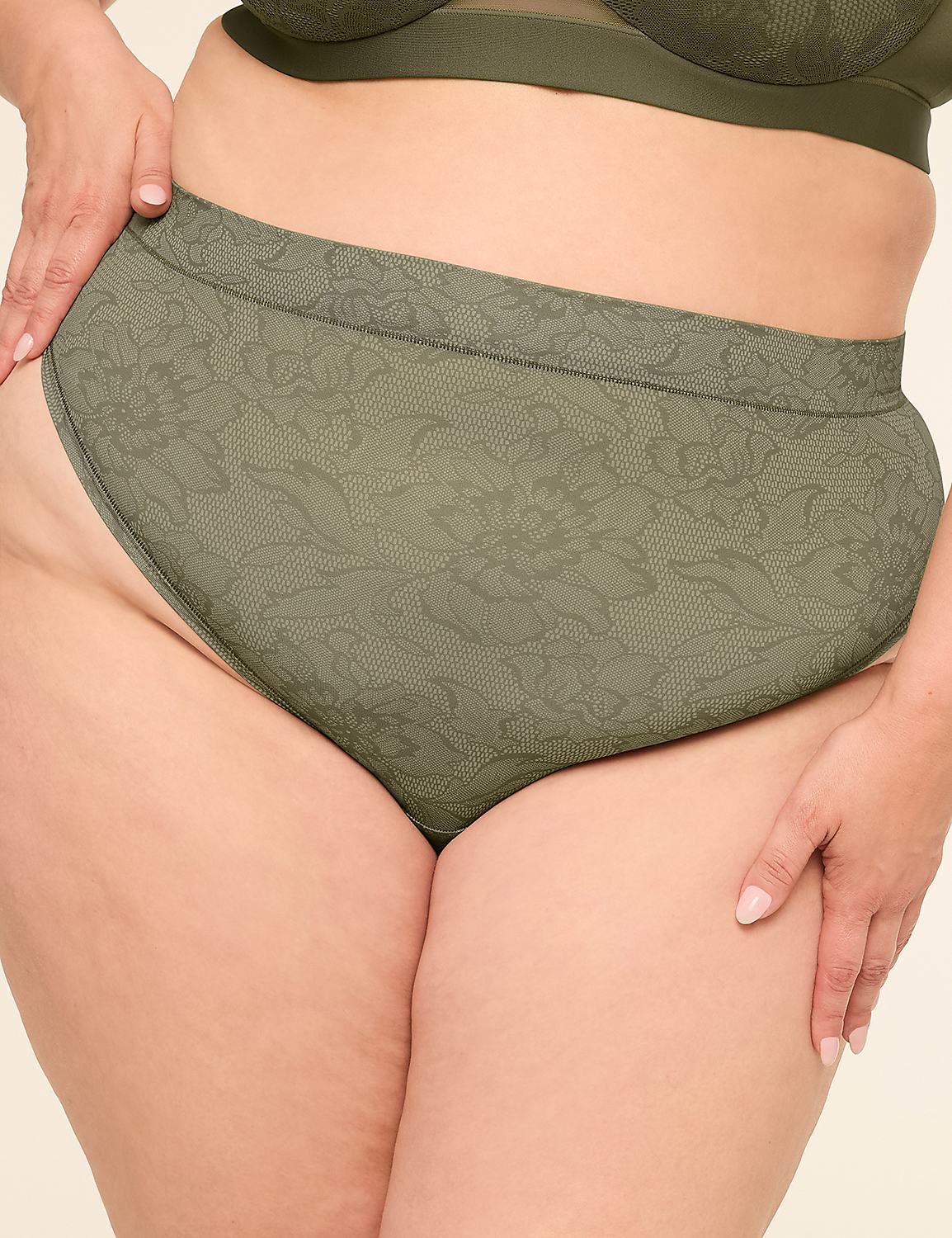 A woman's torso is shown from the waist down, wearing olive green lace-patterned high-waisted underwear and a matching bra, against a plain, light-colored background. Product Image 1
