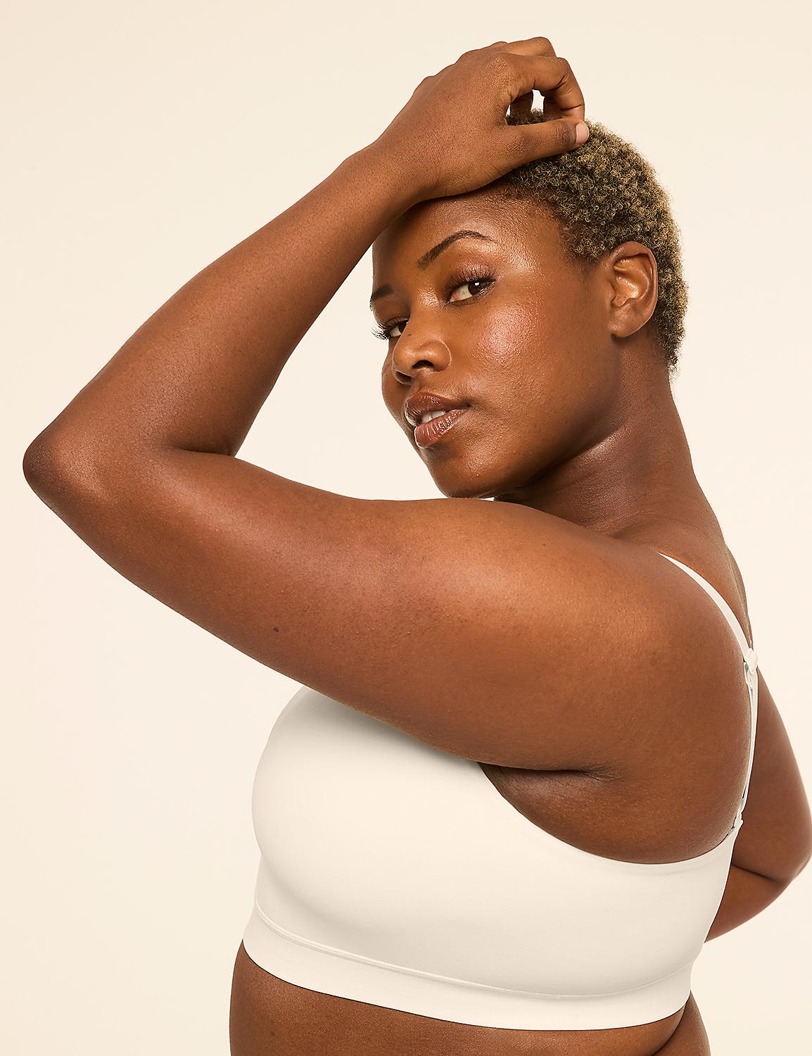 A woman with short, curly hair poses with her arm raised against a plain, light-colored background. Product Image 3