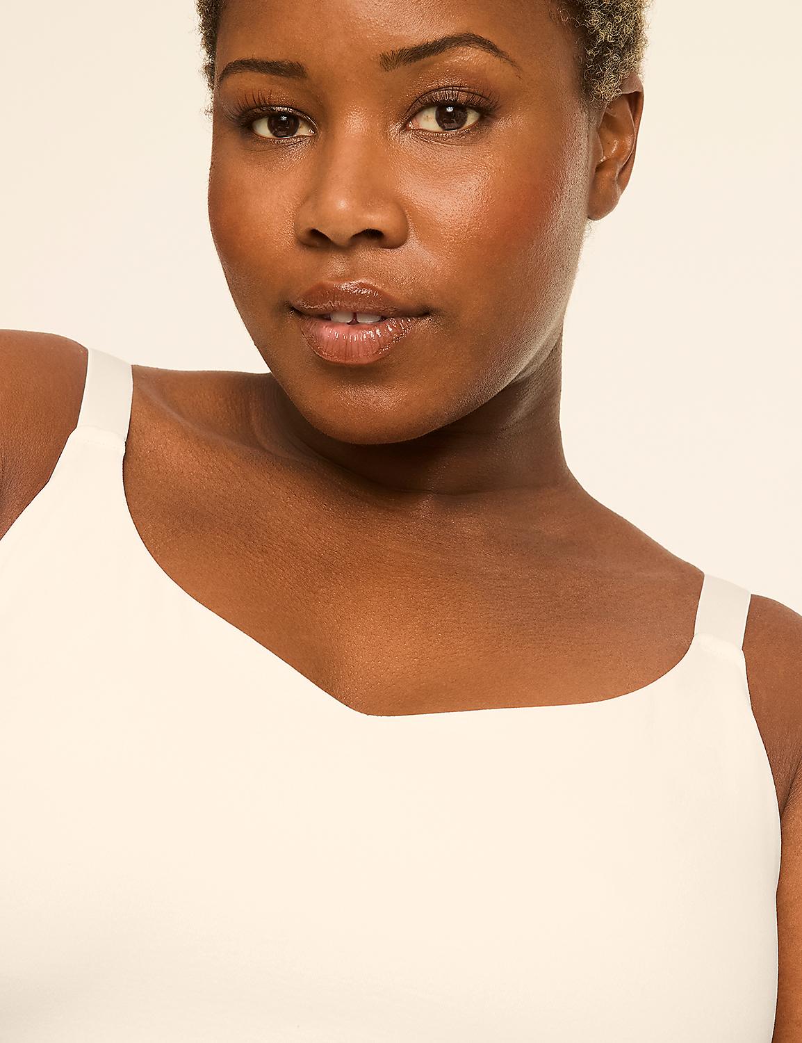 A woman with dark skin and short hair smiles gently in the foreground, wearing a cream-colored top against a plain, light background. Product Image 4