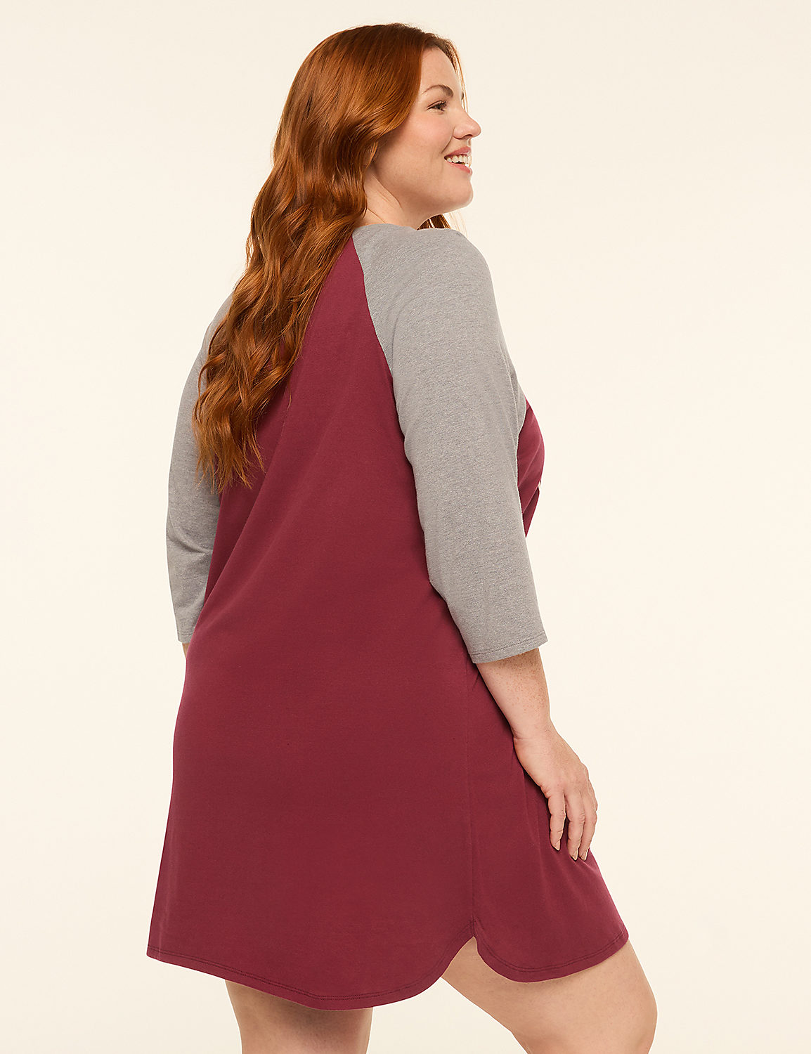 A woman with red hair in a burgundy and gray raglan sleeve dress stands against a plain, light background. Product Image 2